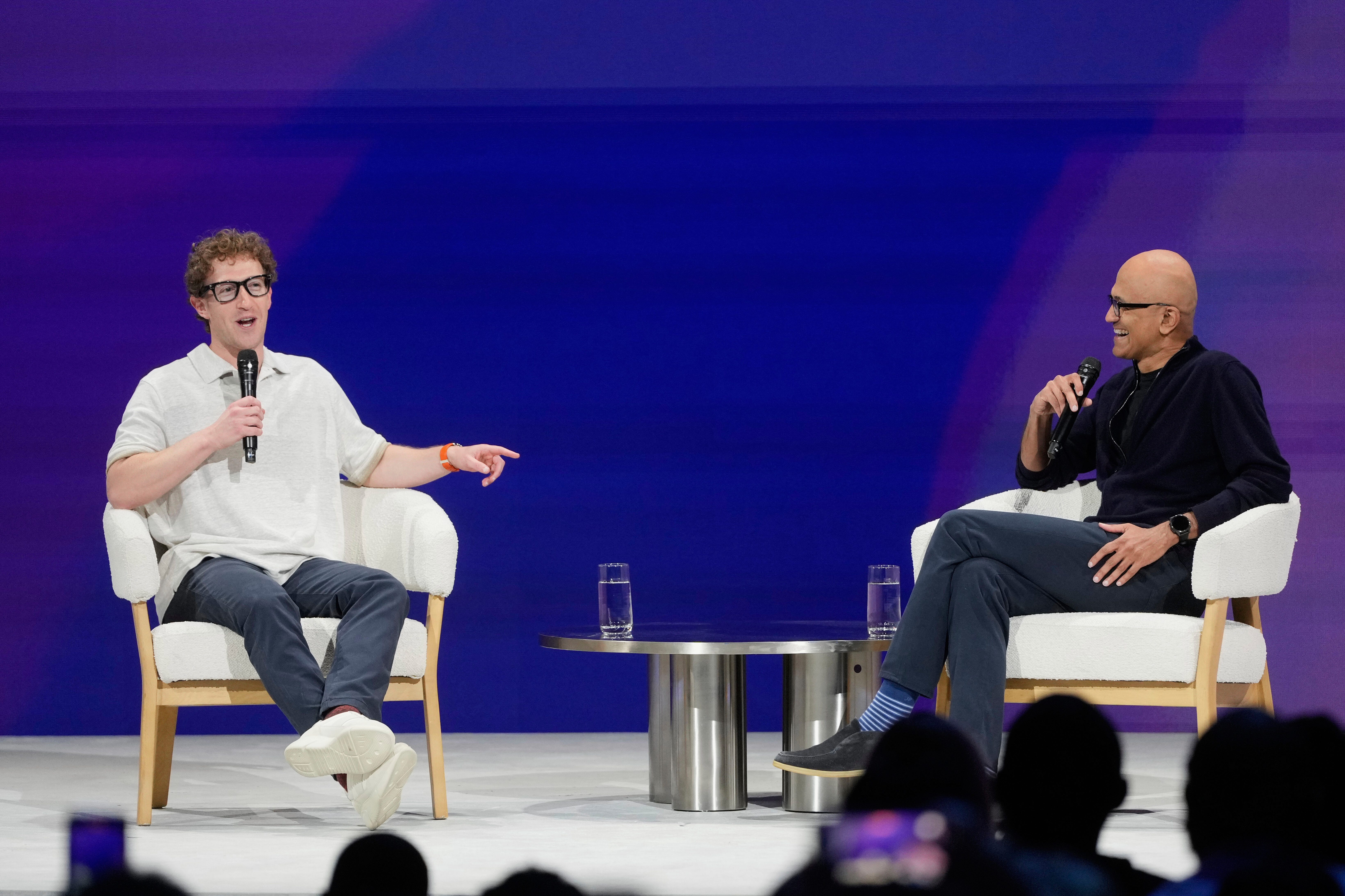 Meta Founder and CEO Mark Zuckerberg, left, speaks with Microsoft Chairman and CEO Satya Nadella at LlamaCon 2025