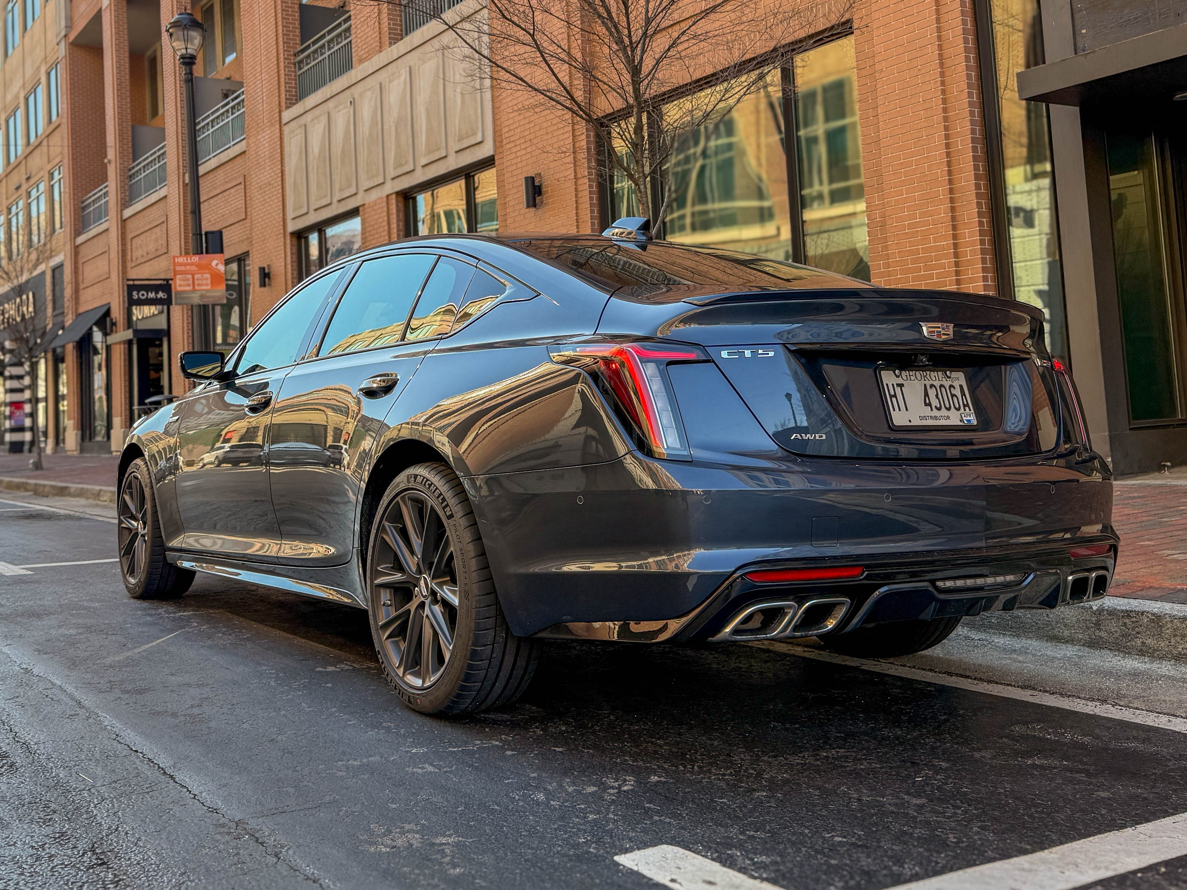 The left rear corner of a gray 2025 Cadillac CT5-V sports sedan parked on the street.