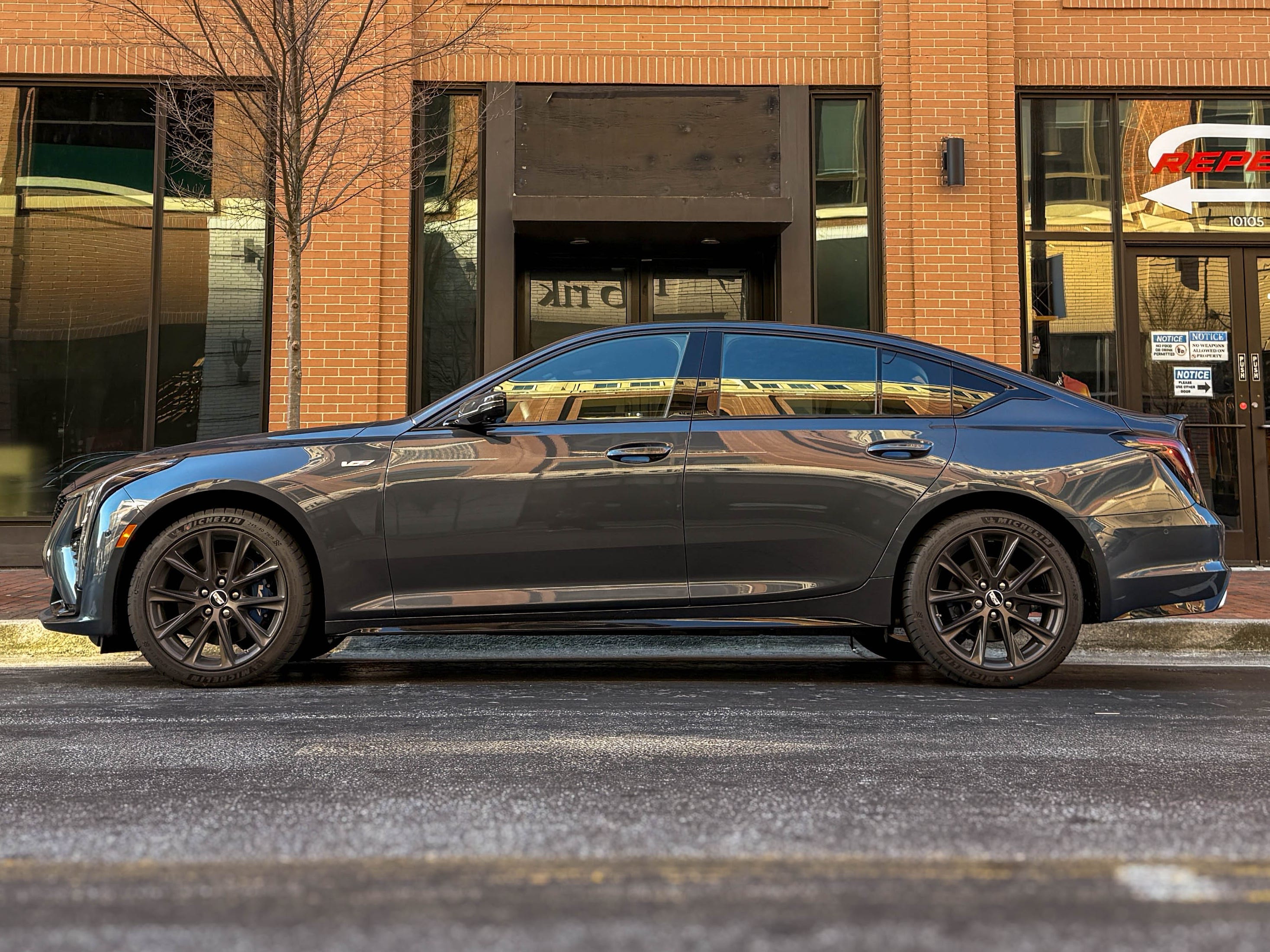 The left side of a gray 2025 Cadillac CT5-V sports sedan parked on the street.