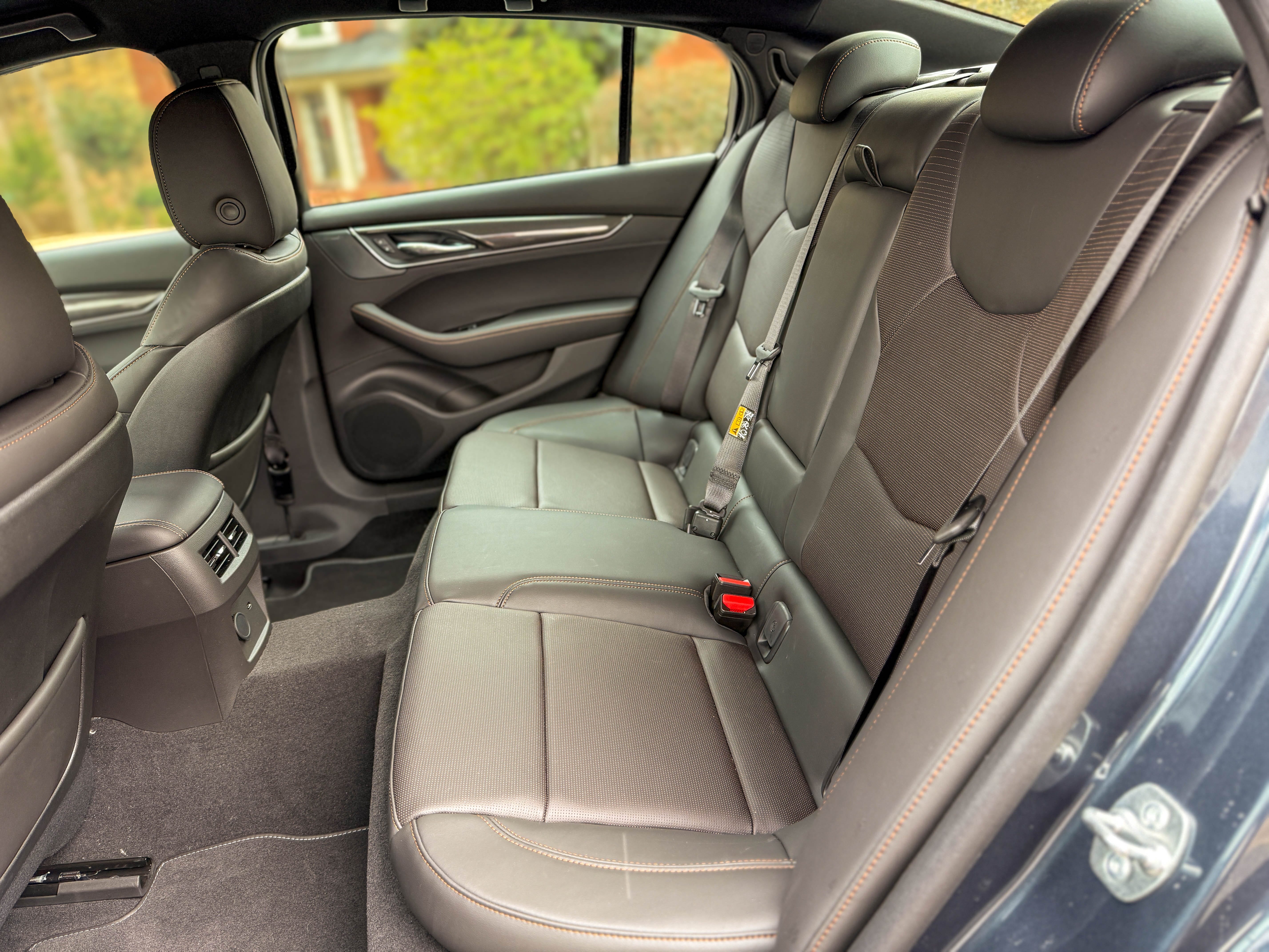 The black leather rear seats in a 2025 Cadillac CT5-V sports sedan parked on the street.