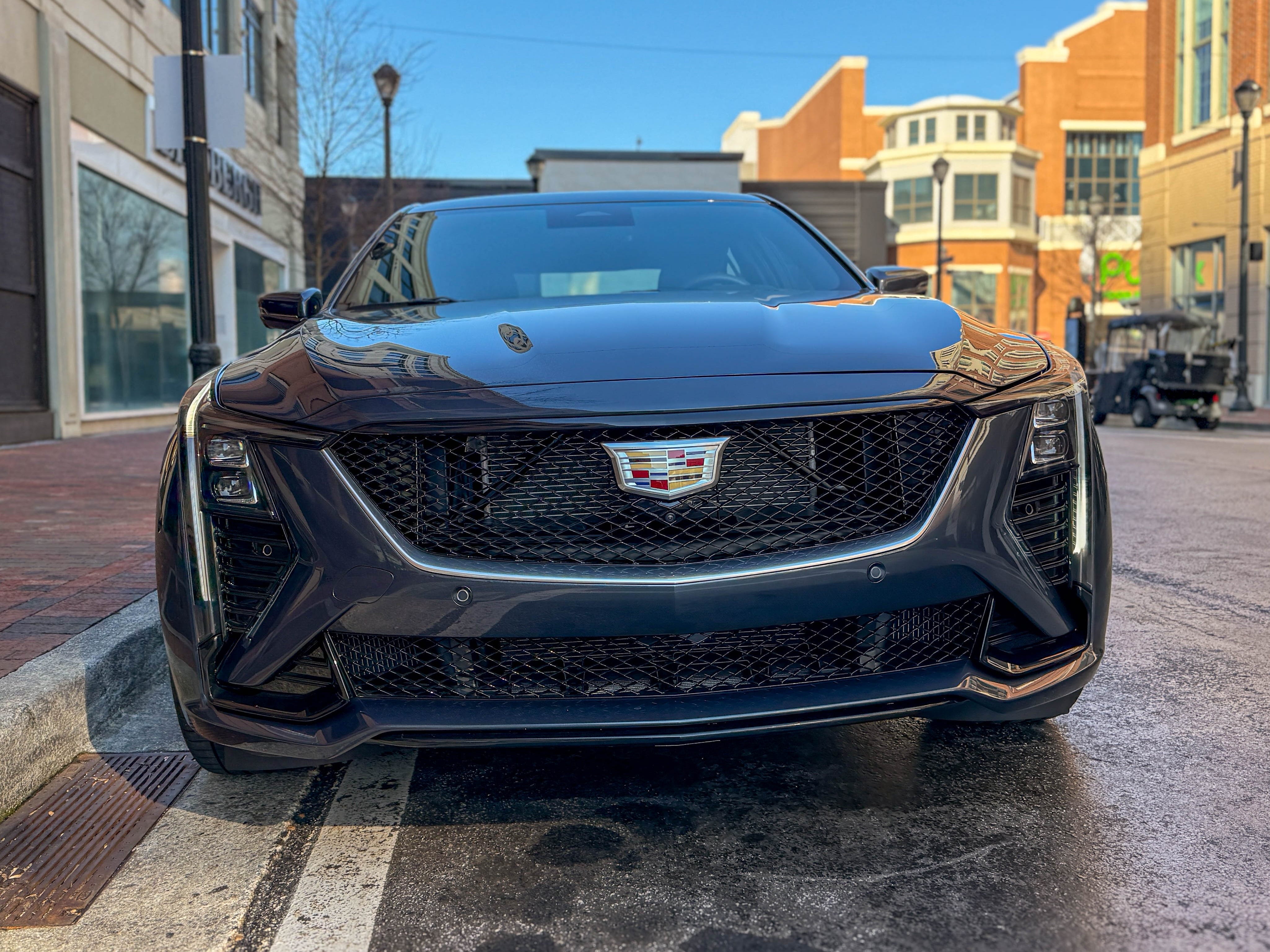 The front of a gray 2025 Cadillac CT5-V sports sedan parked on the street.
