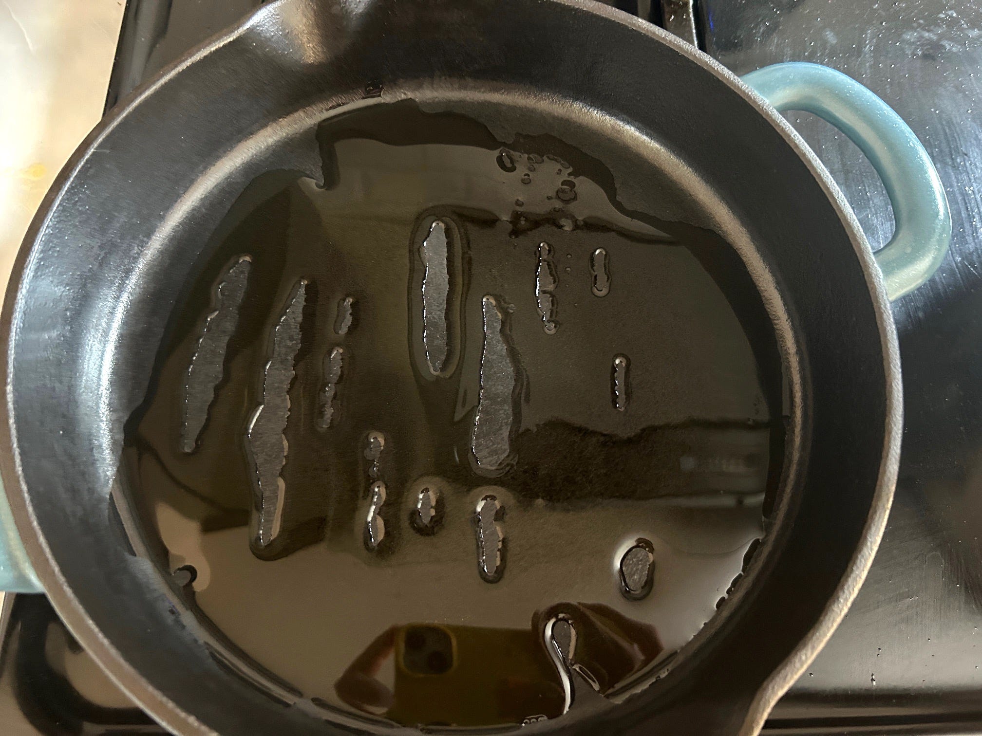 Adding olive oil to pan for Meghan Markle's spring garden pasta salad