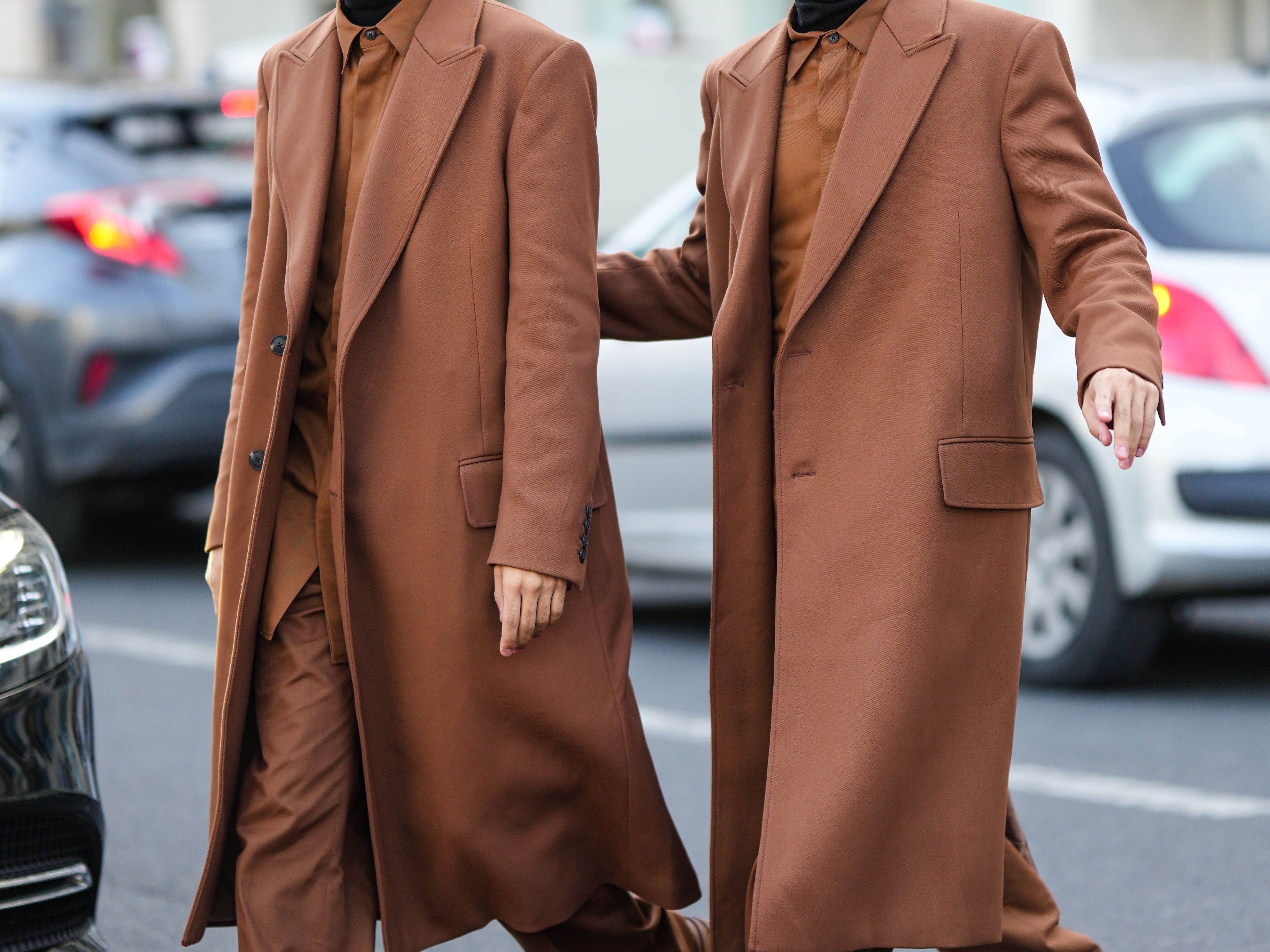 Two men wearing all brown outfits shoes, pans, jackets