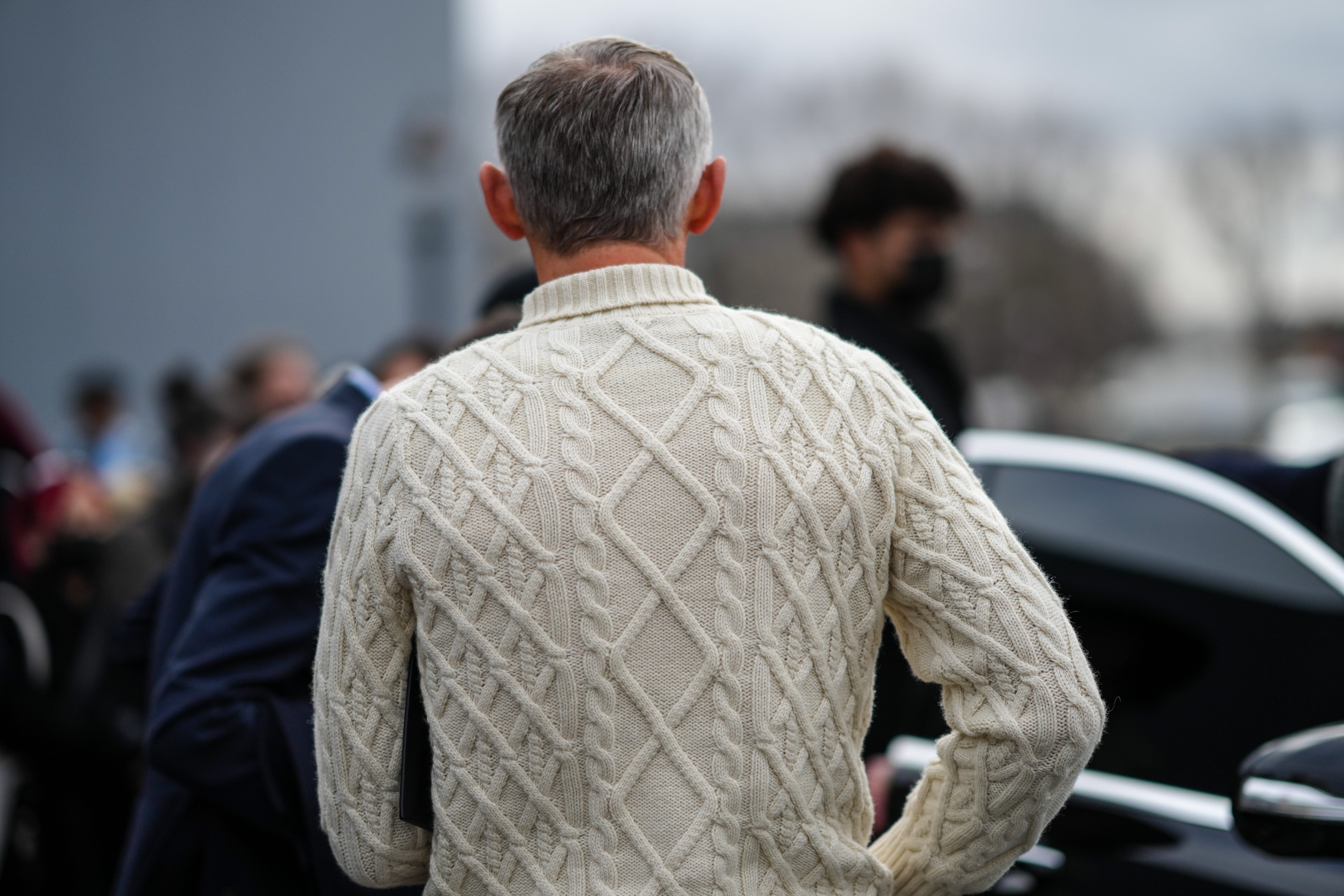 Back of man wearing cableknit sweater