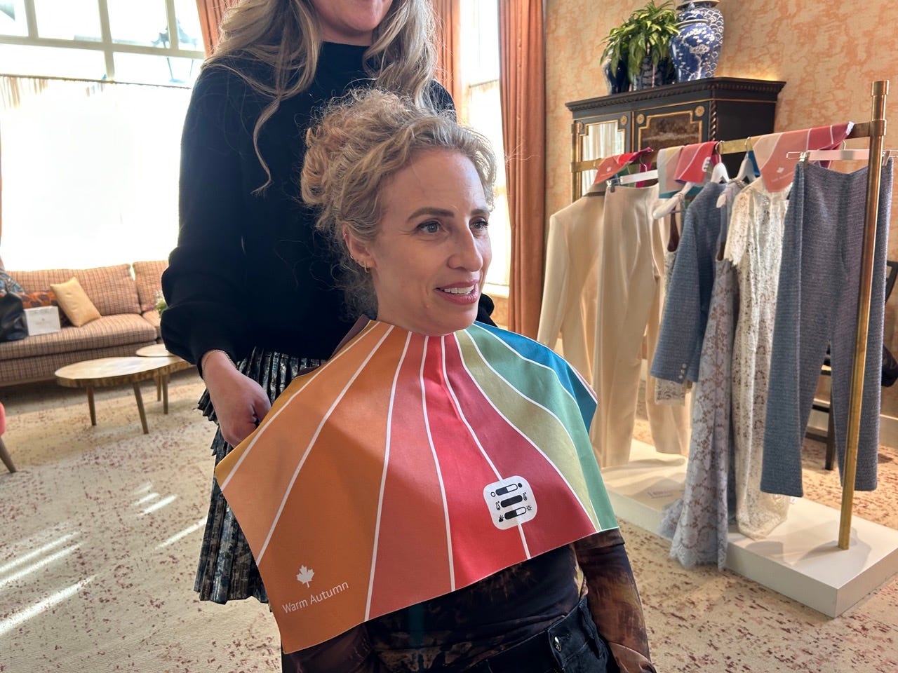 Author Alesandra Dubin wearing a colorful mat draped on her by stylist