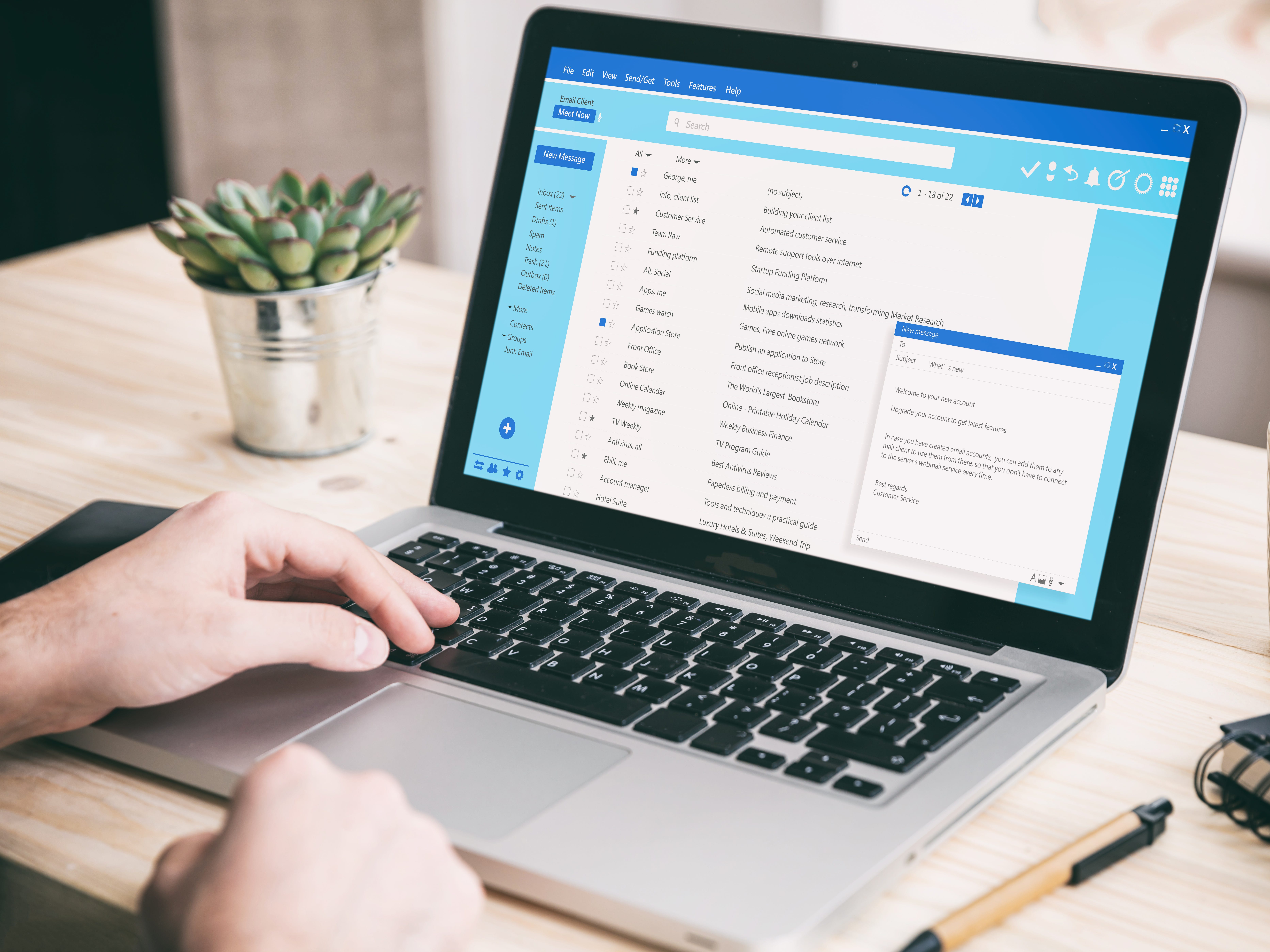 A person reading and composing emails on a laptop.