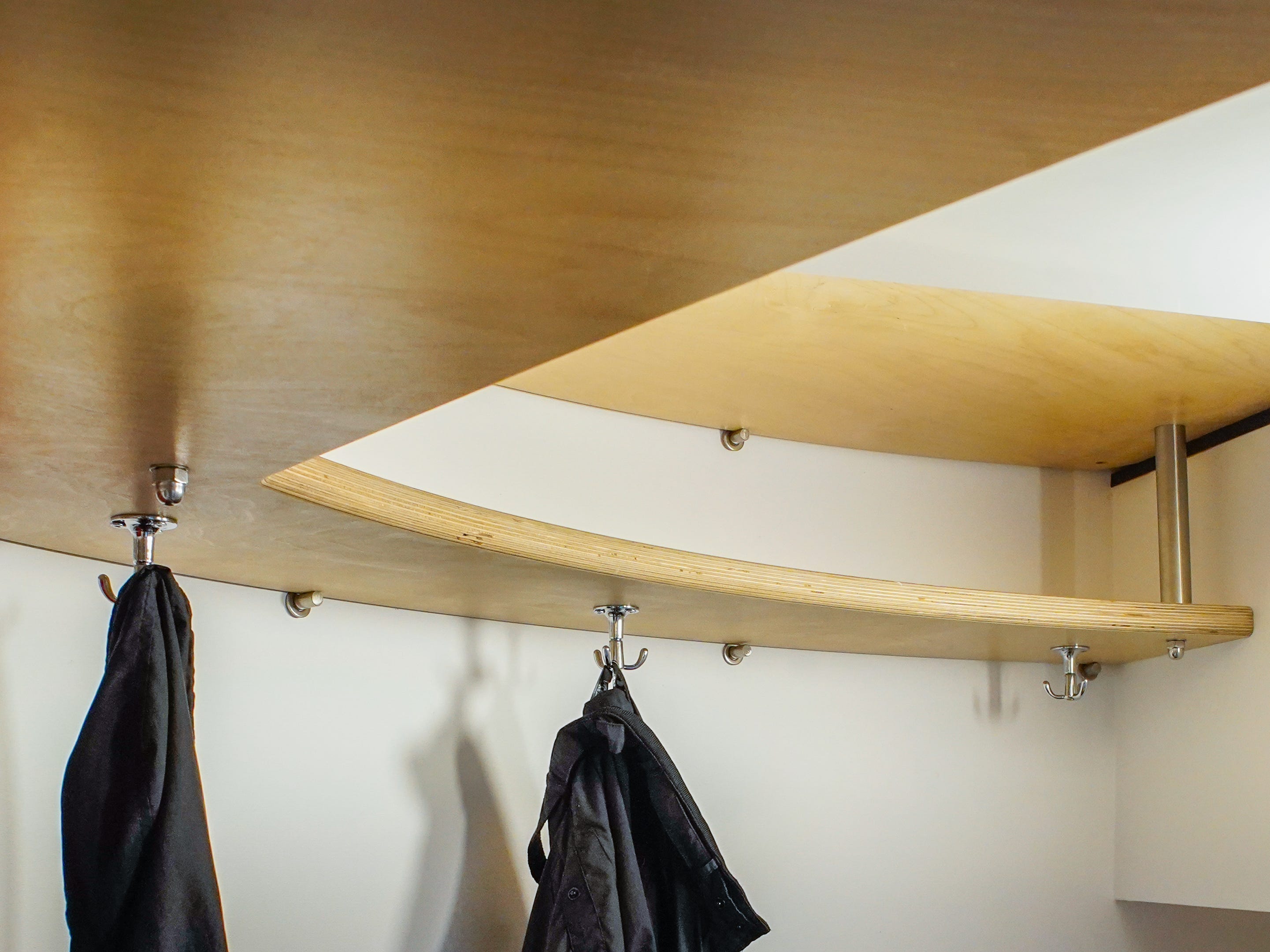 The author's coats hang in the Airbnb.
