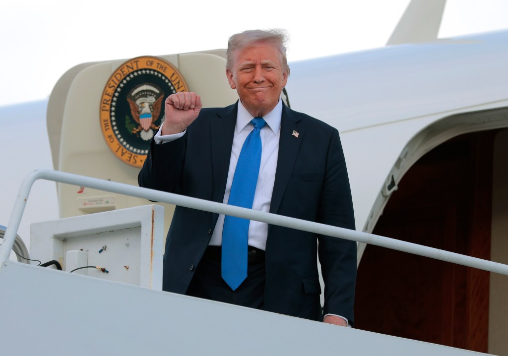 President Donald Trump stepping off Air Force One at Tuscaloosa National Airport, preparing to address the University of Alabama graduating class.