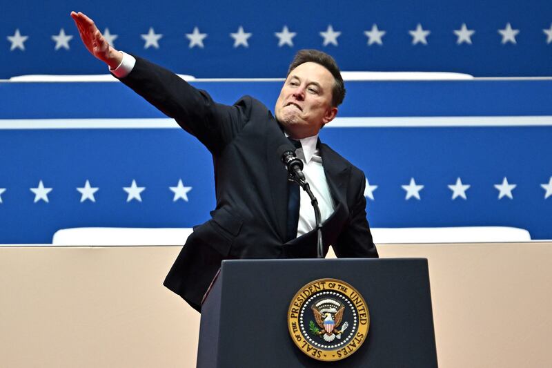 Elon Musk gestures in a move that looks like a Nazi salute as he speaks during the inaugural parade inside Capitol One Arena, in Washington, DC.