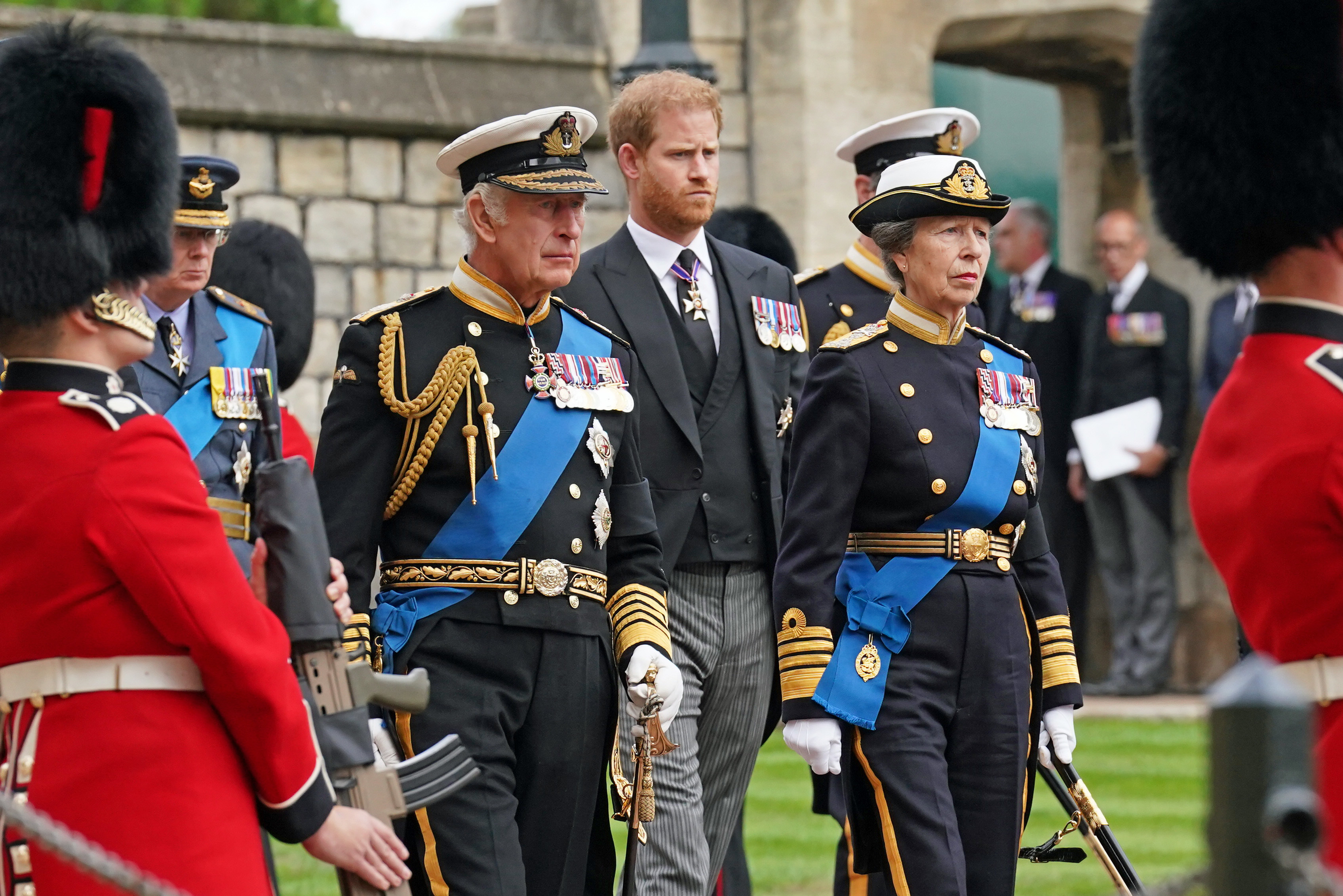 Prince Harry and King Charles in royal regalia. 