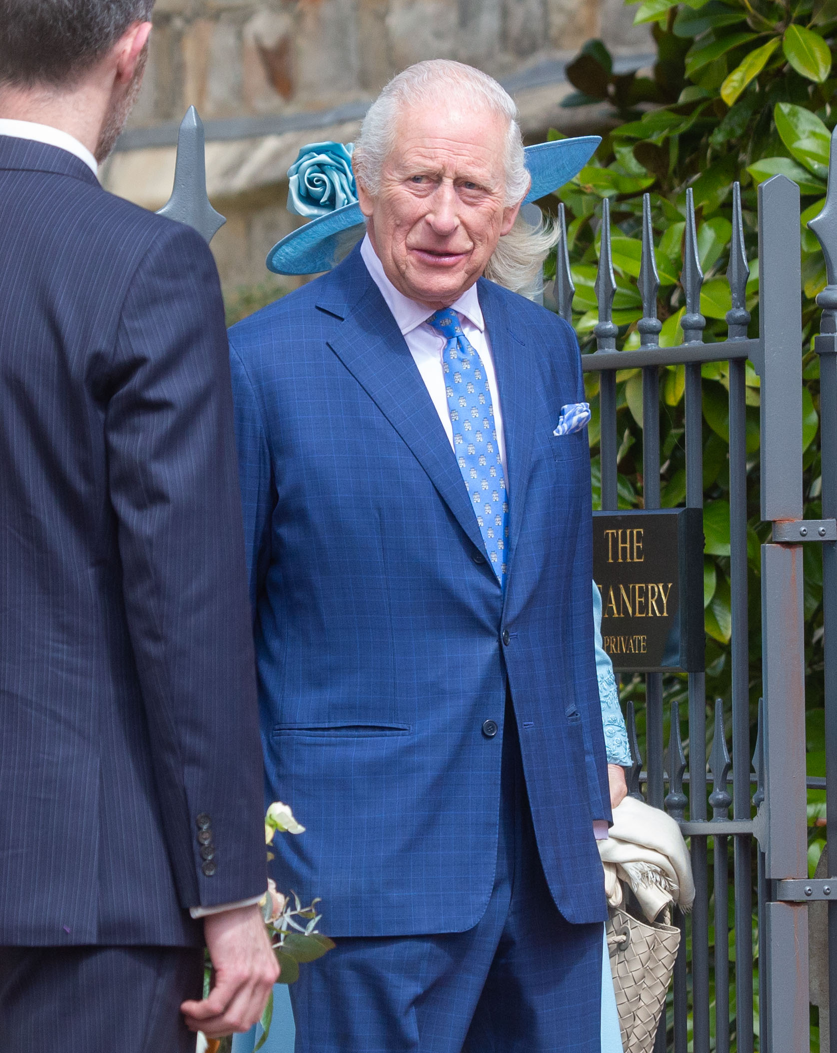 King Charles III outdoors in a blue suit. 