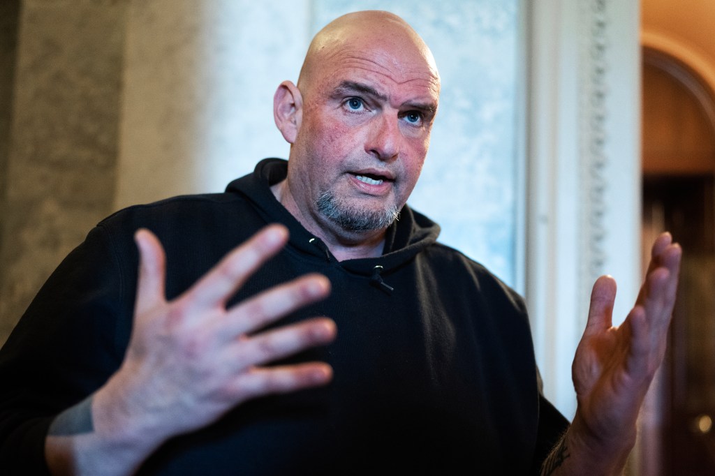 Sen. John Fetterman talks with a reporter after the senate luncheons in the U.S. Capitol on Tuesday, March 11, 2025.