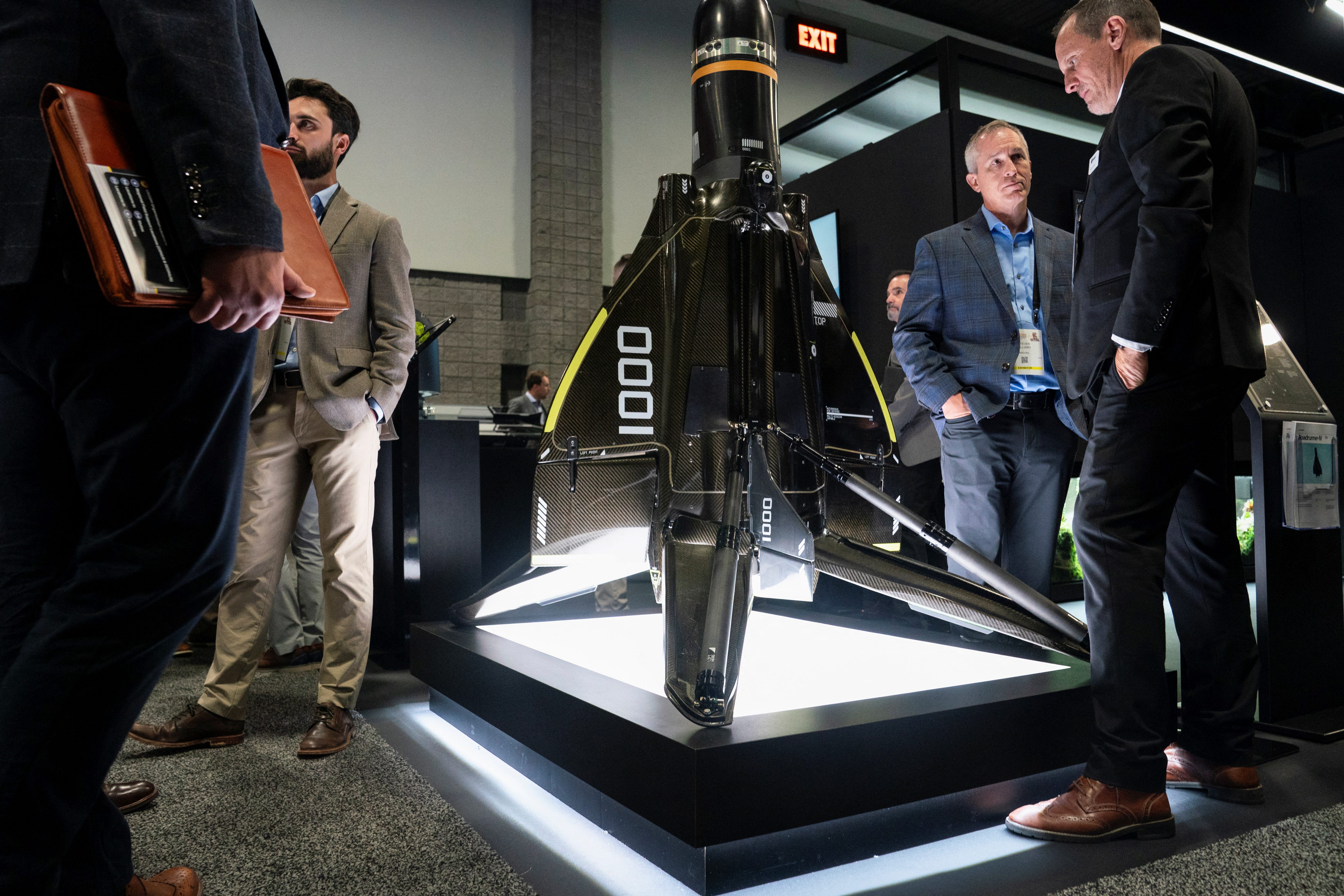 Attendees inspect the Anduril Roadrunner unmanned aircraft