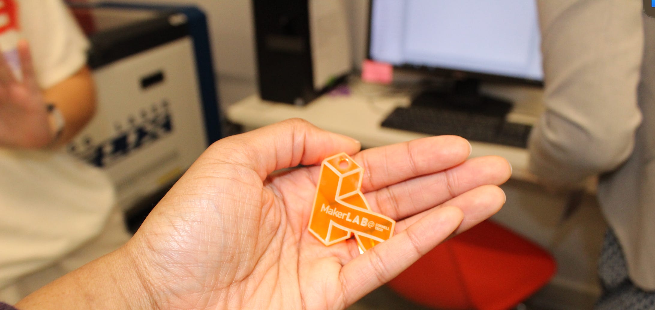 A laser-printed keychain that's a logo of the Cornell Tech MakerLAB