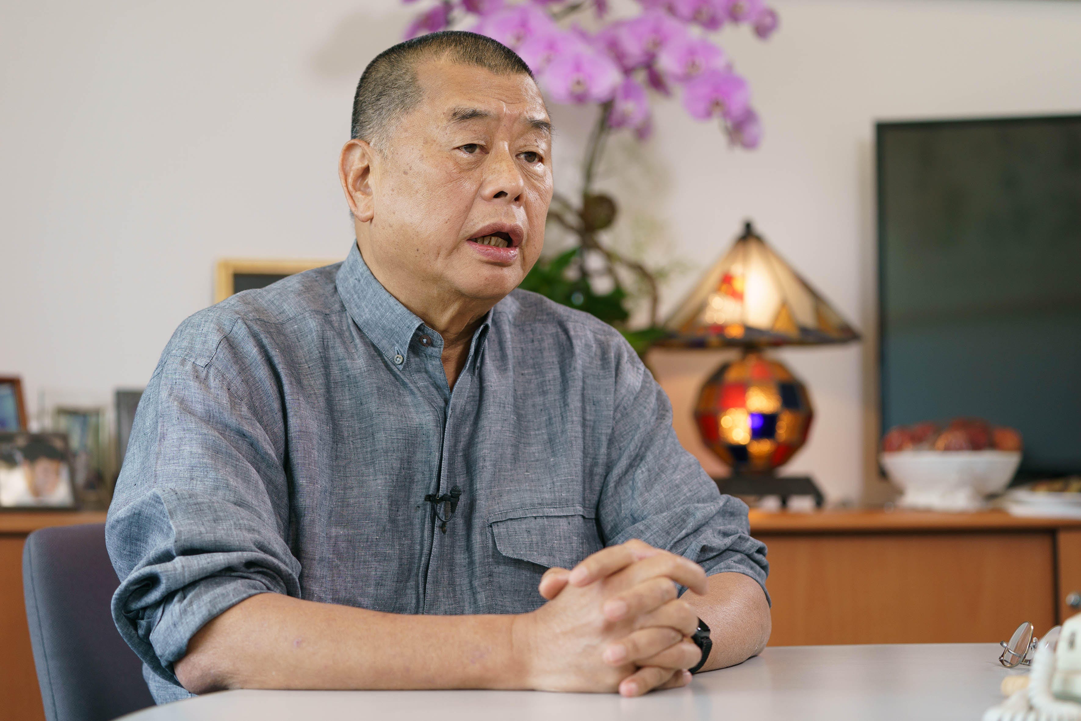 Jimmy Lai sitting with grey shirt