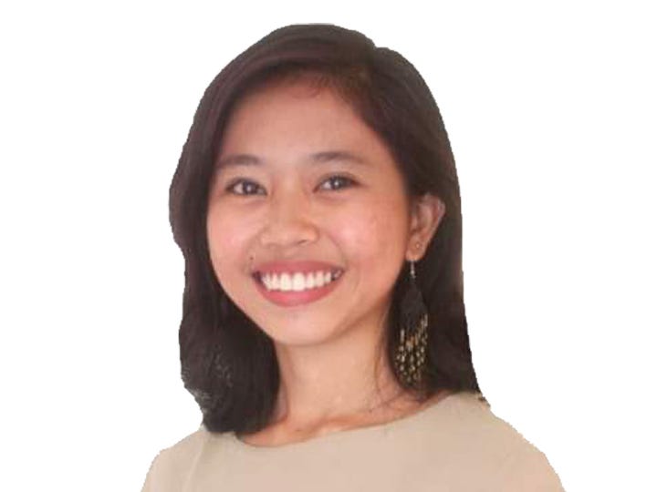 Frenchie Mae Cumpio with brown shirt in front of white background