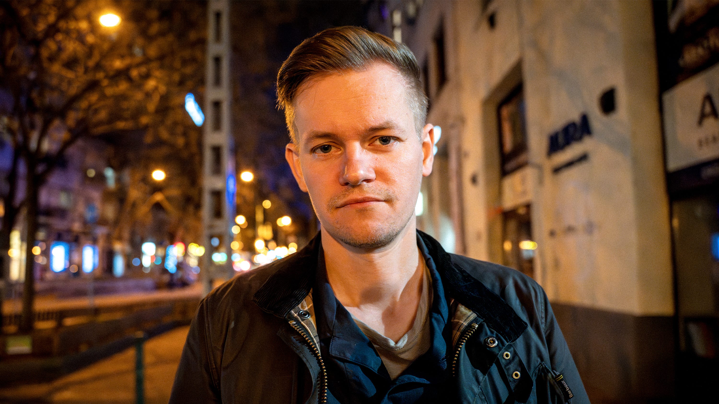 Joakim Medin with black jacket on street with trees