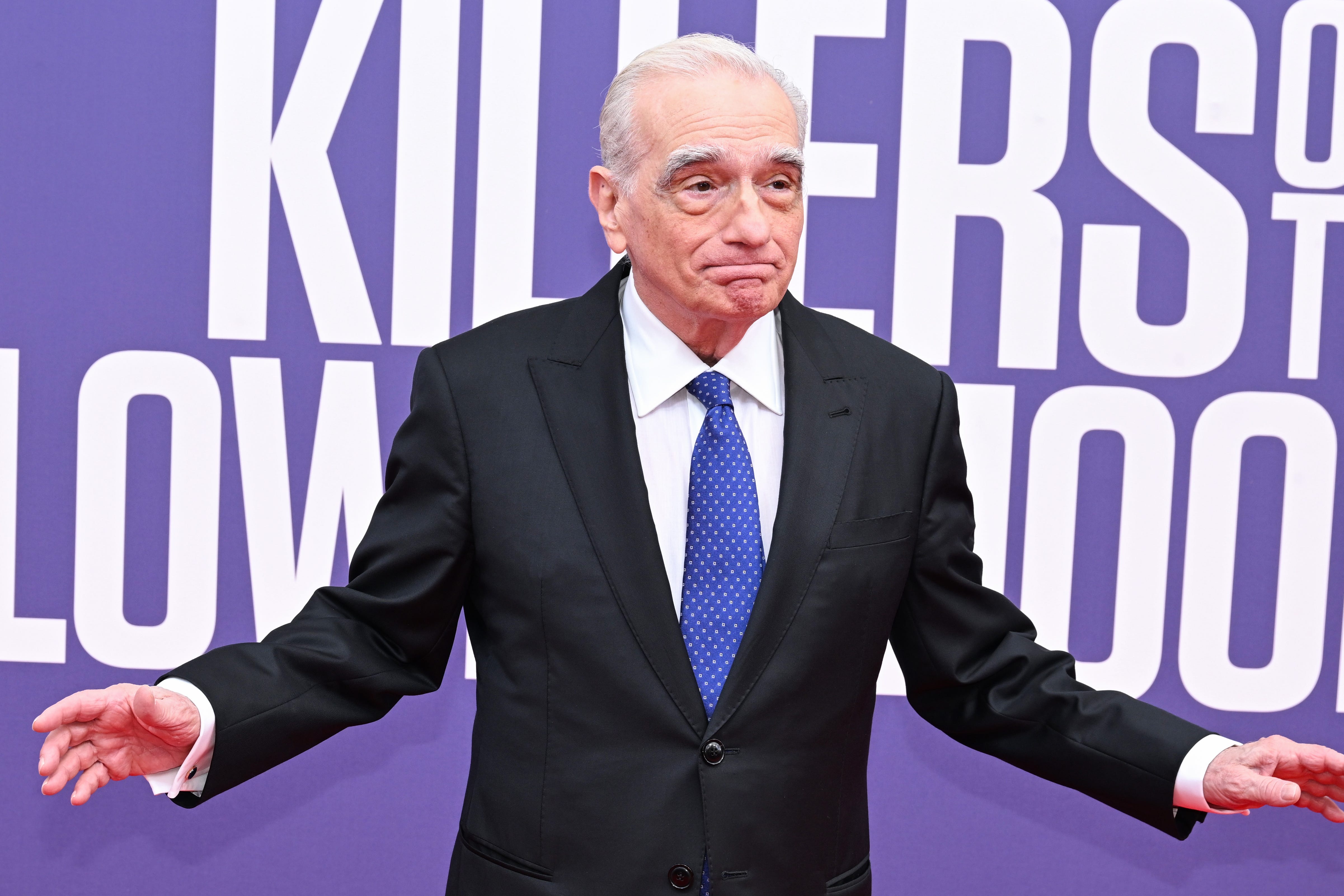 Martin Scorsese in a dark suit and blue tie