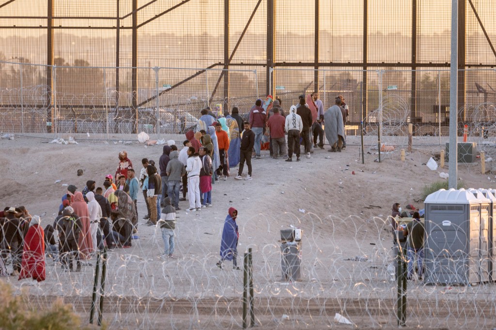 Immigrants wait to be transported and processed by U.S. Border Patrol officers at the U.S.-Mexico border on May 12, 2023 in El Paso, Texas.