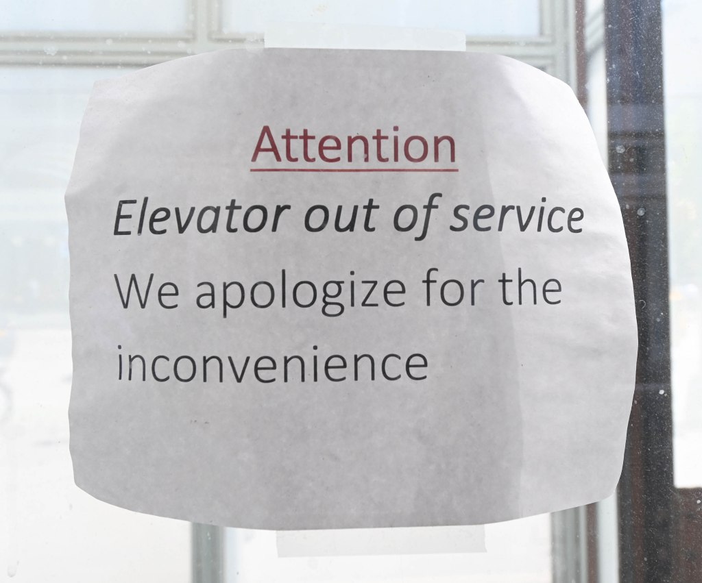 Sign that says Attention elevator out of service we apologize for the inconvenience