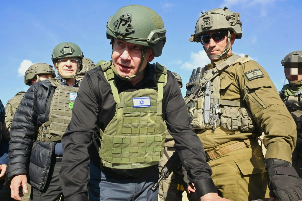 This handout picture released by the Israeli government press office (GPO) shows Israeli Prime Minister Benjamin Netanyahu (C) during a visit to the northern Gaza Strip, on April 15, 2025.