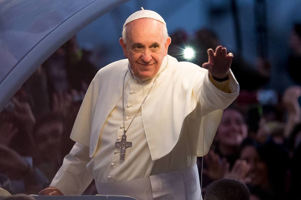 Pope Francis waves from the Popemobile on his way to attend the Via Crucis on Copacabana Beach during World Youth Day celebrations on July 26, 2013 in Rio de Janeiro, Brazil.