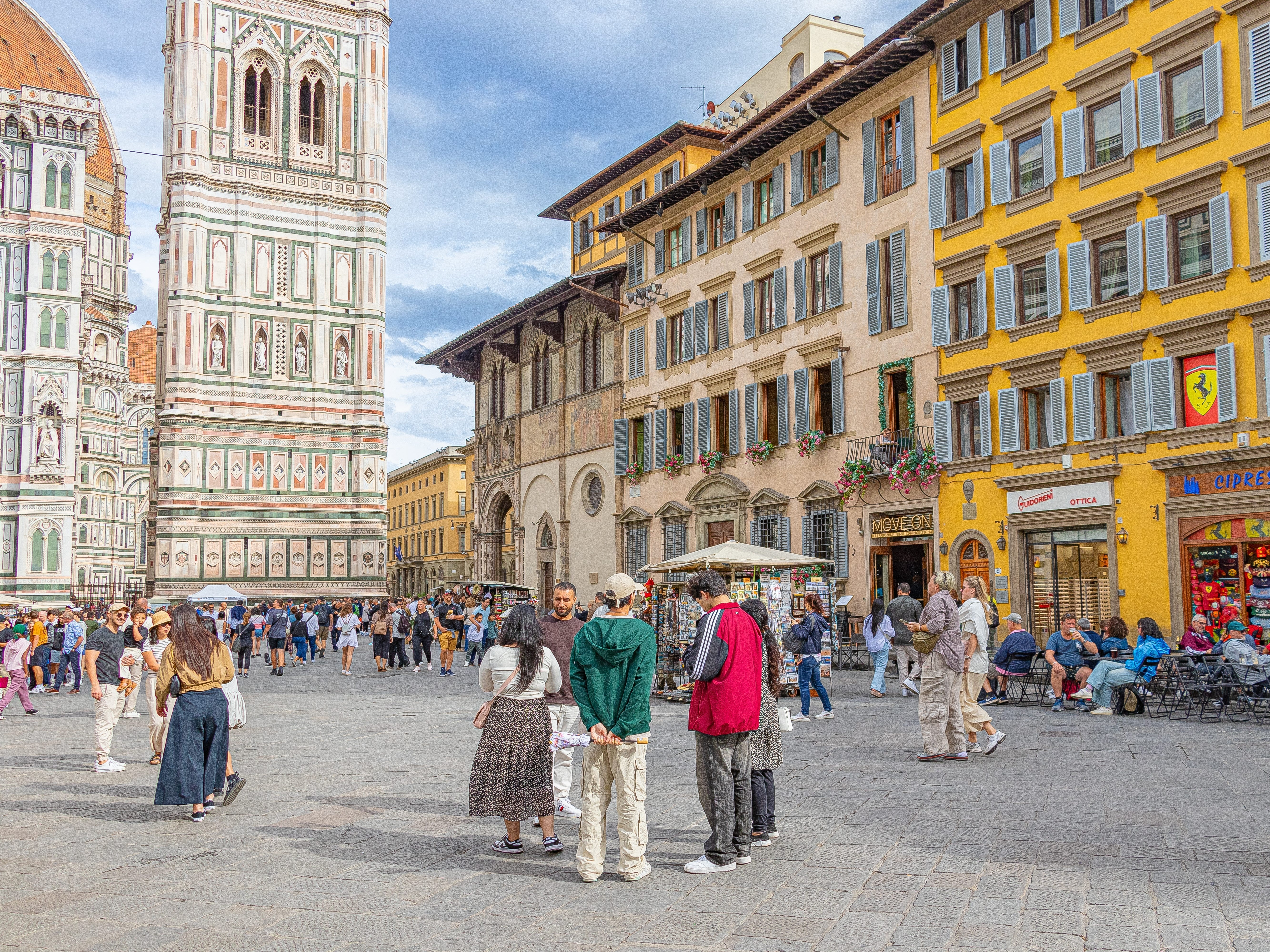 People gathering in a lively square in Florence, Italy.