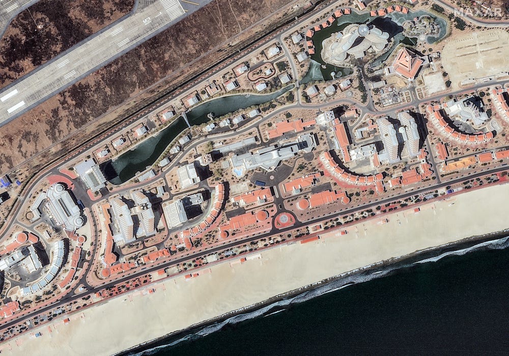 A Maxar Technologies satellite image of part of the Wonsan Kalma development as of February 2025, showing multiple hotels and apartment buildings along a sandy beach.