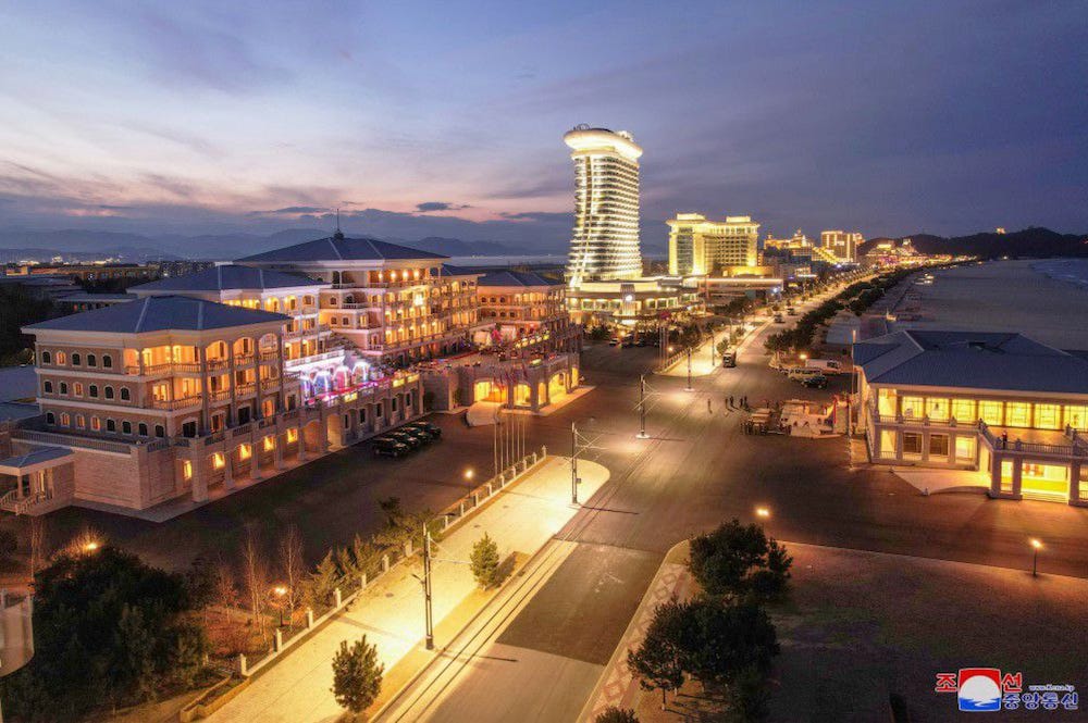 A nightscape of Wonsan Kalma Beach resort in North Korea, showing multiple hotels and apartments along a lit-up strip of road. Image supplied by state-controlled media.