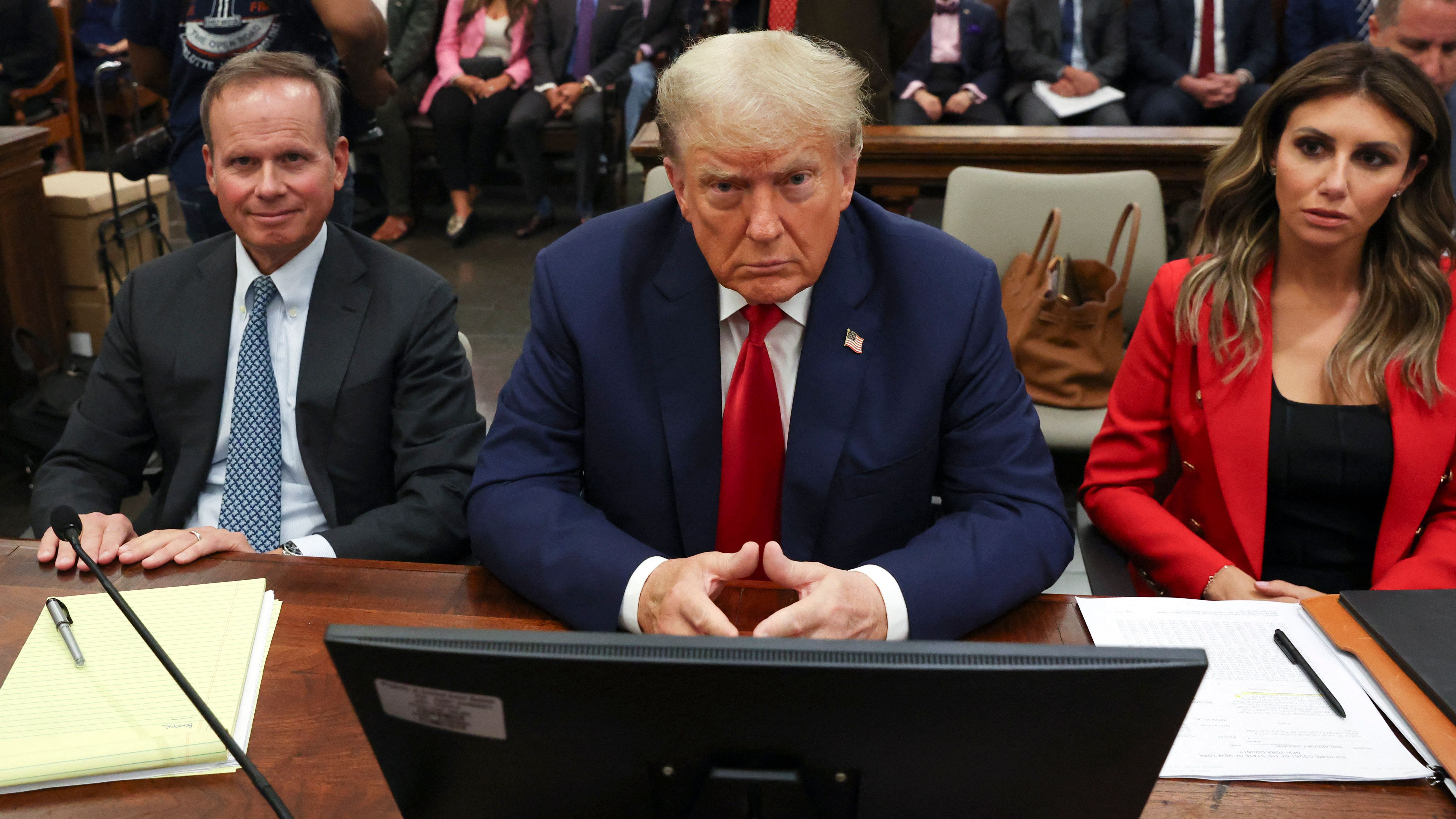 Trump sits beside his lawyers at his civil fraud trial.