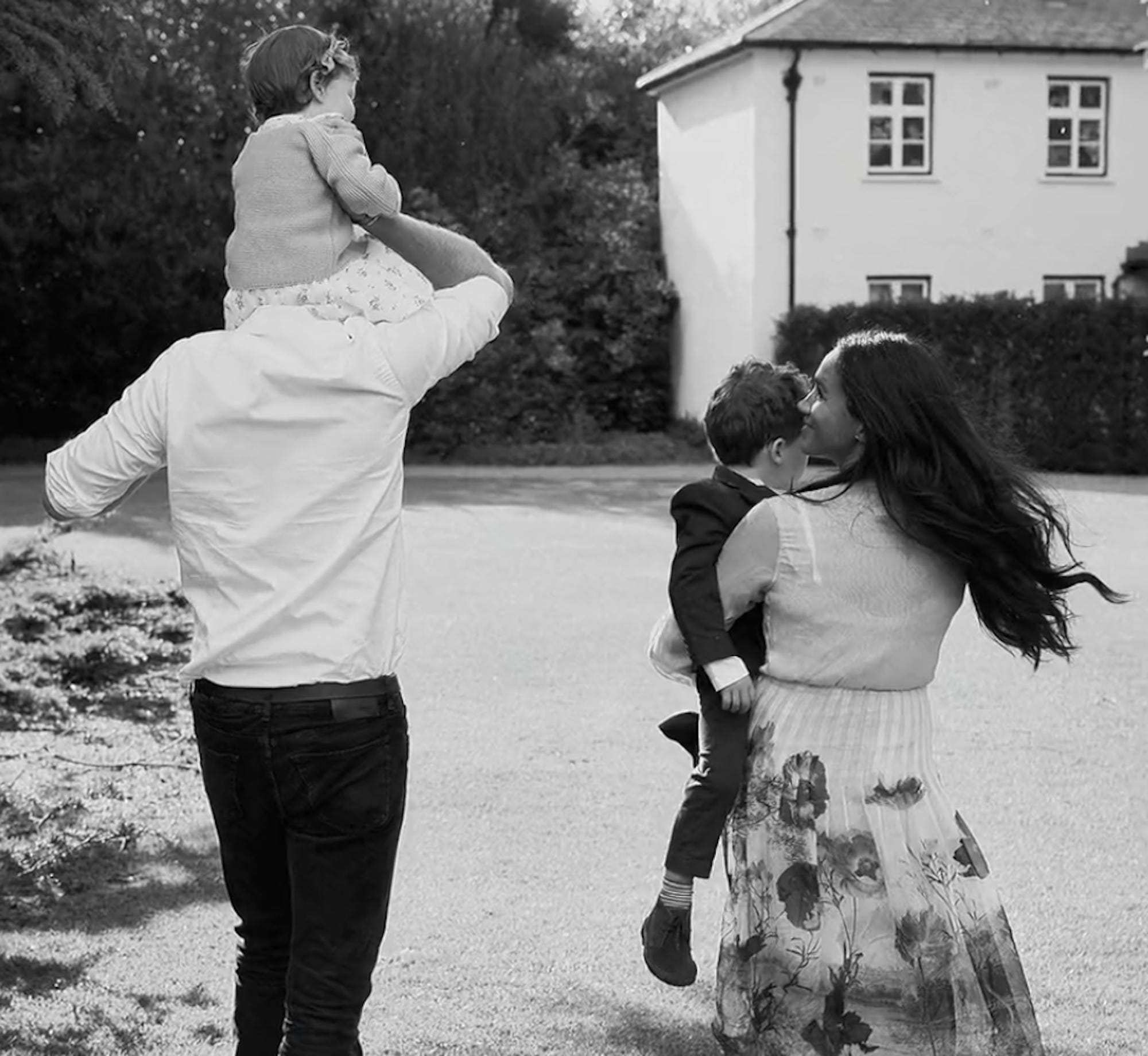 Prince Harry, Meghan Markle, Lilibet, and Archie walk together.
