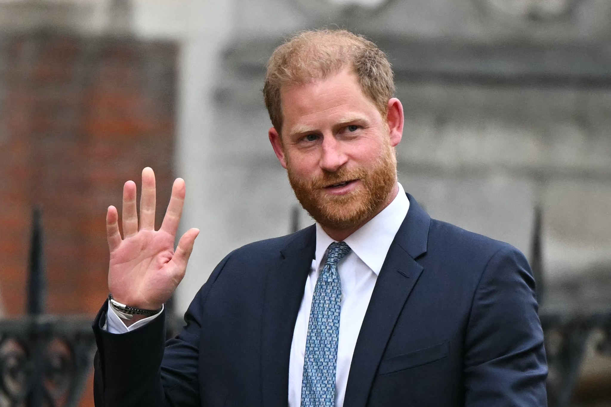Prince Harry waving while leaving court in 2025