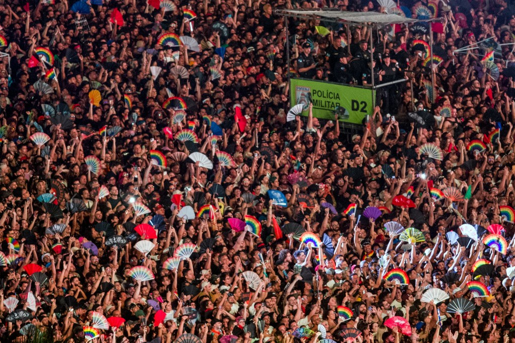 Military Police officers stand on an elevated platform as fans wait for the beginning of the free mega-concert of US pop star Lady Gaga at Copacabana beach in Rio de Janeiro, Brazil