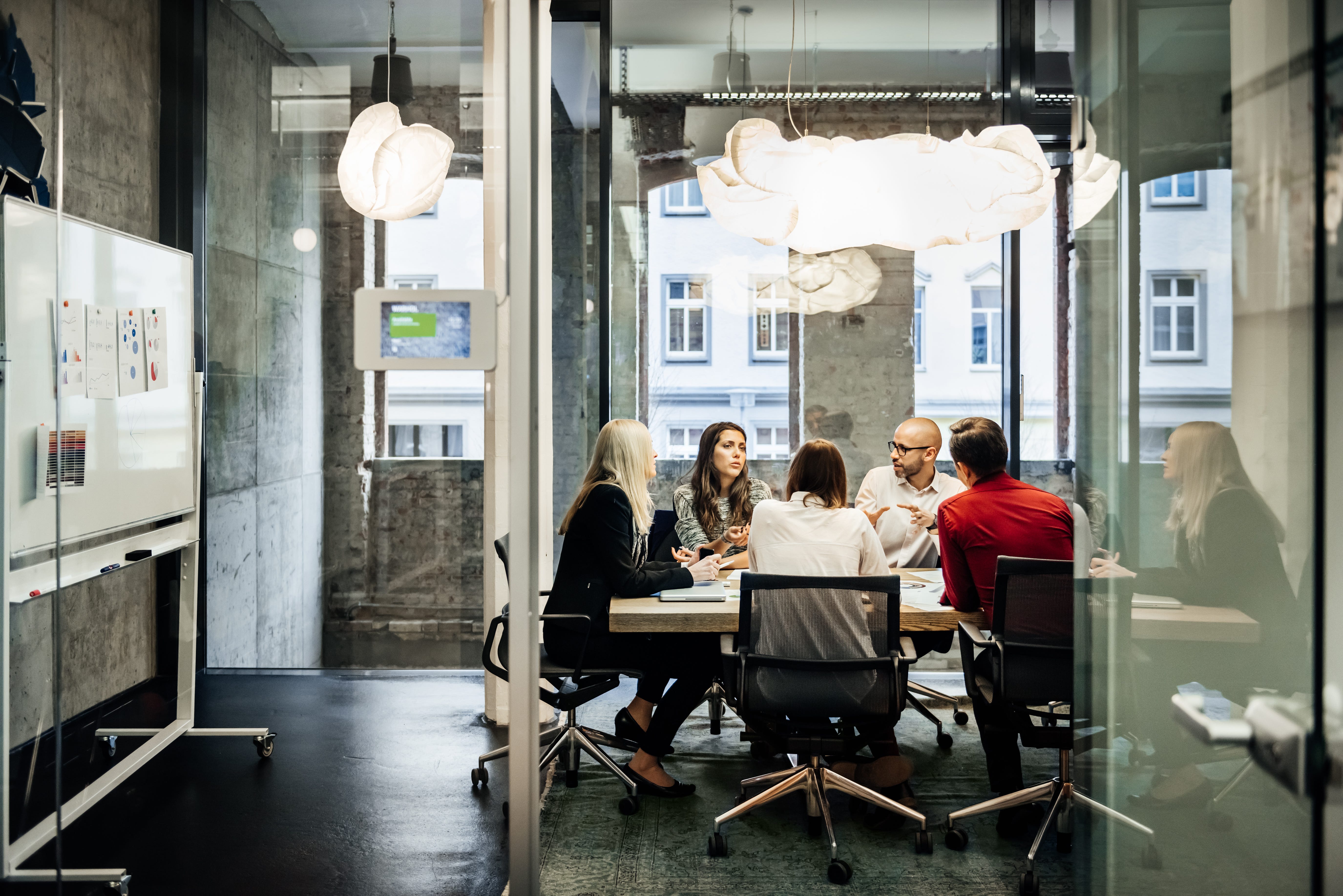 Office workers sit around a desk