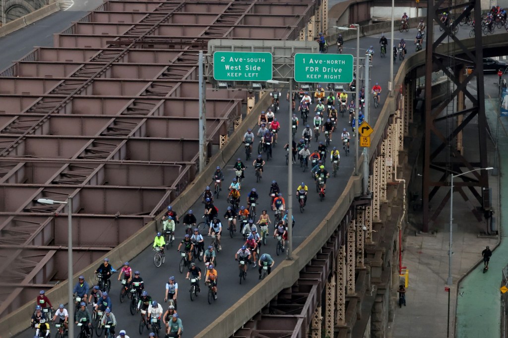 Thousands of cyclists, including various celebrities, crossing the Ed Koch Queensboro Bridge during the annual 2025 Bike Tour in New York City