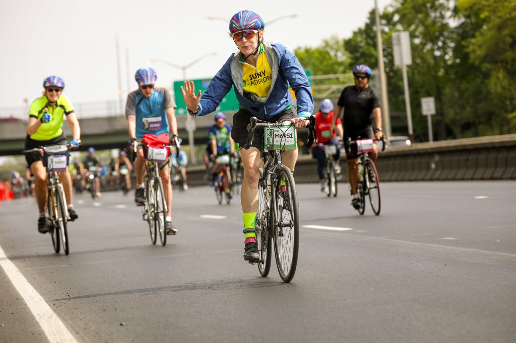 Thousands of cyclists participating in the 5 Boro Bike Tour in New York City, pedaling over the Verrazano Narrows Bridge from Brooklyn into Staten Island