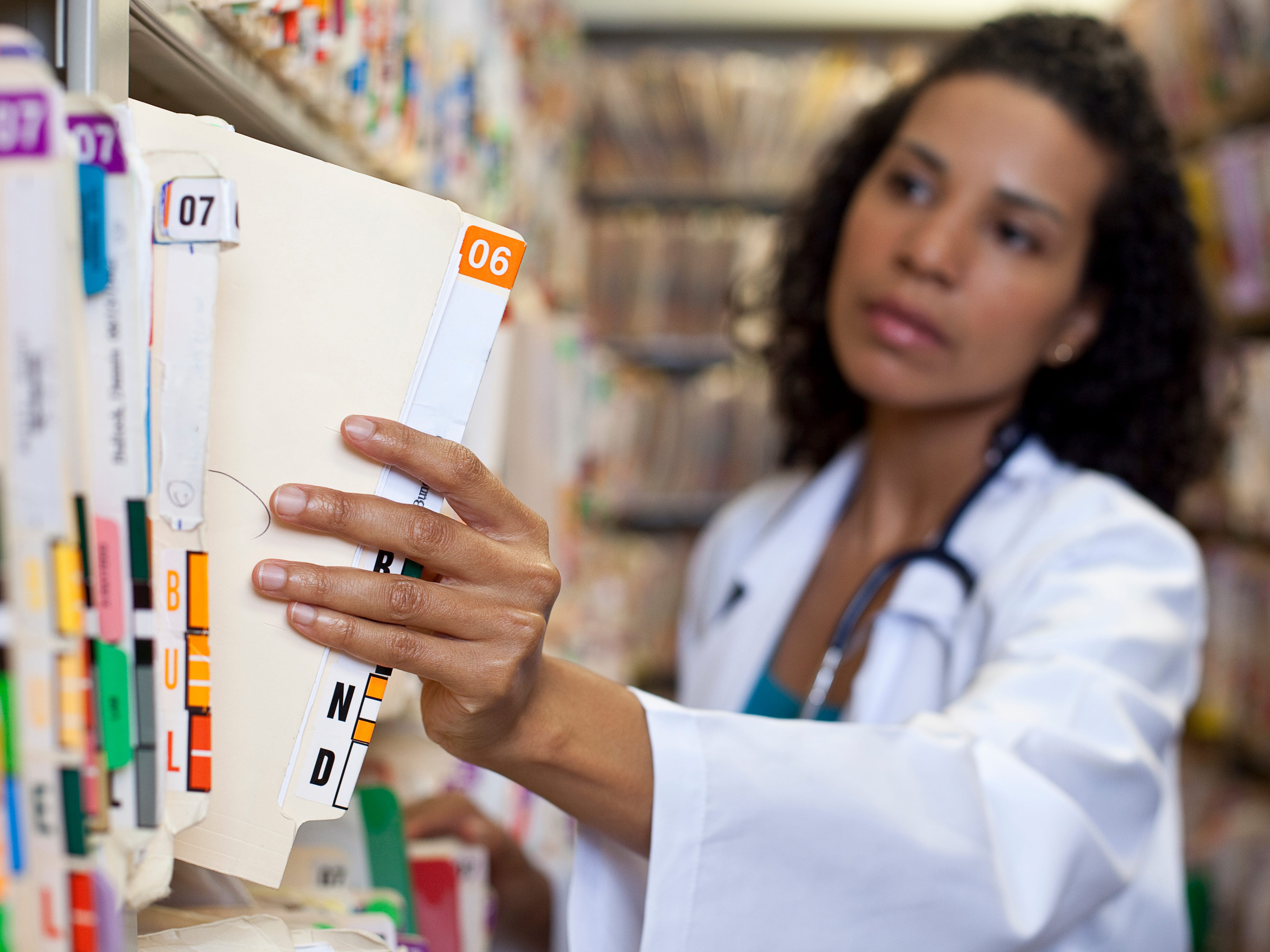 Healthcare worker holding patient files