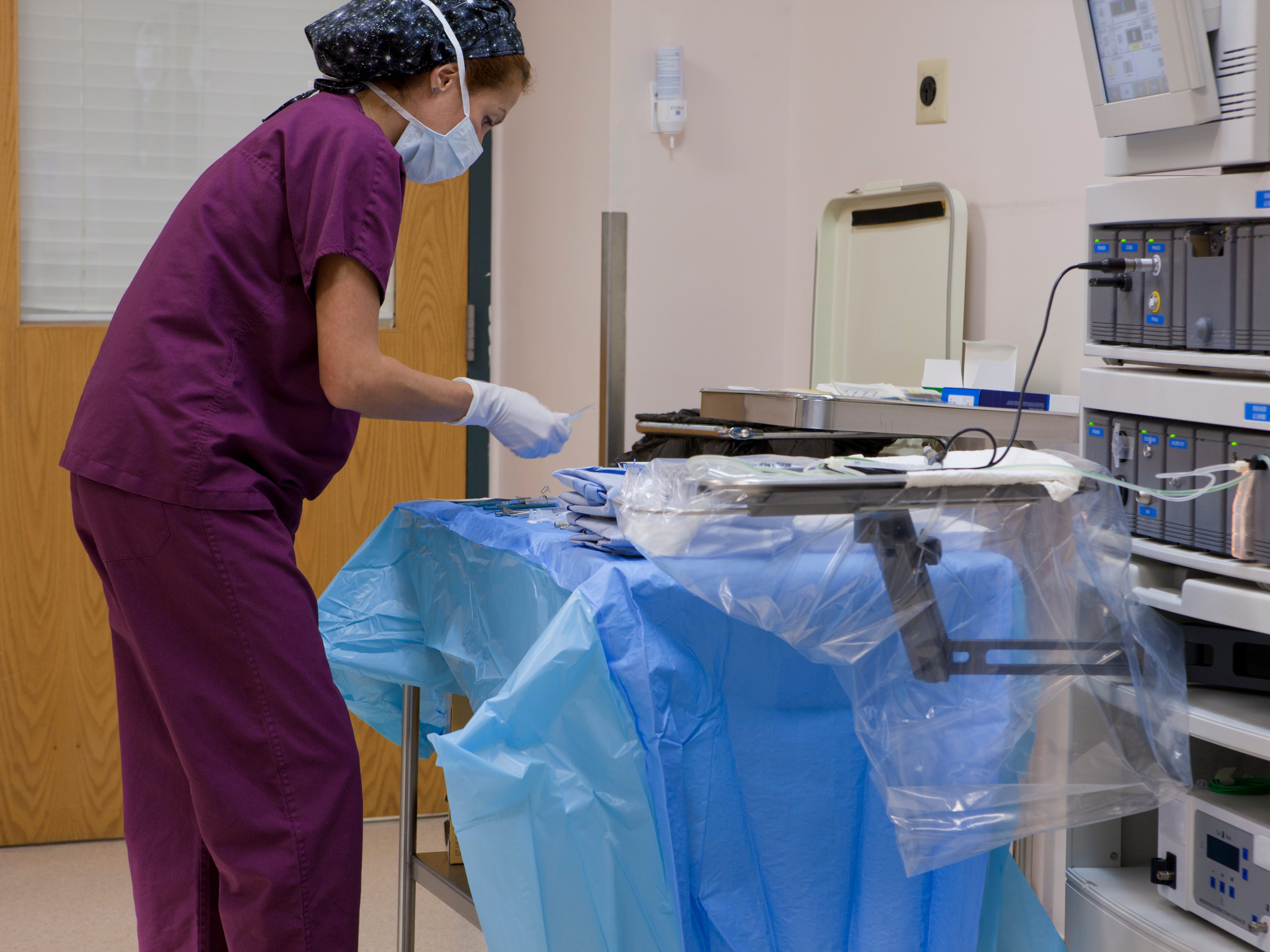 A surgical technologist setting up instruments before surgery