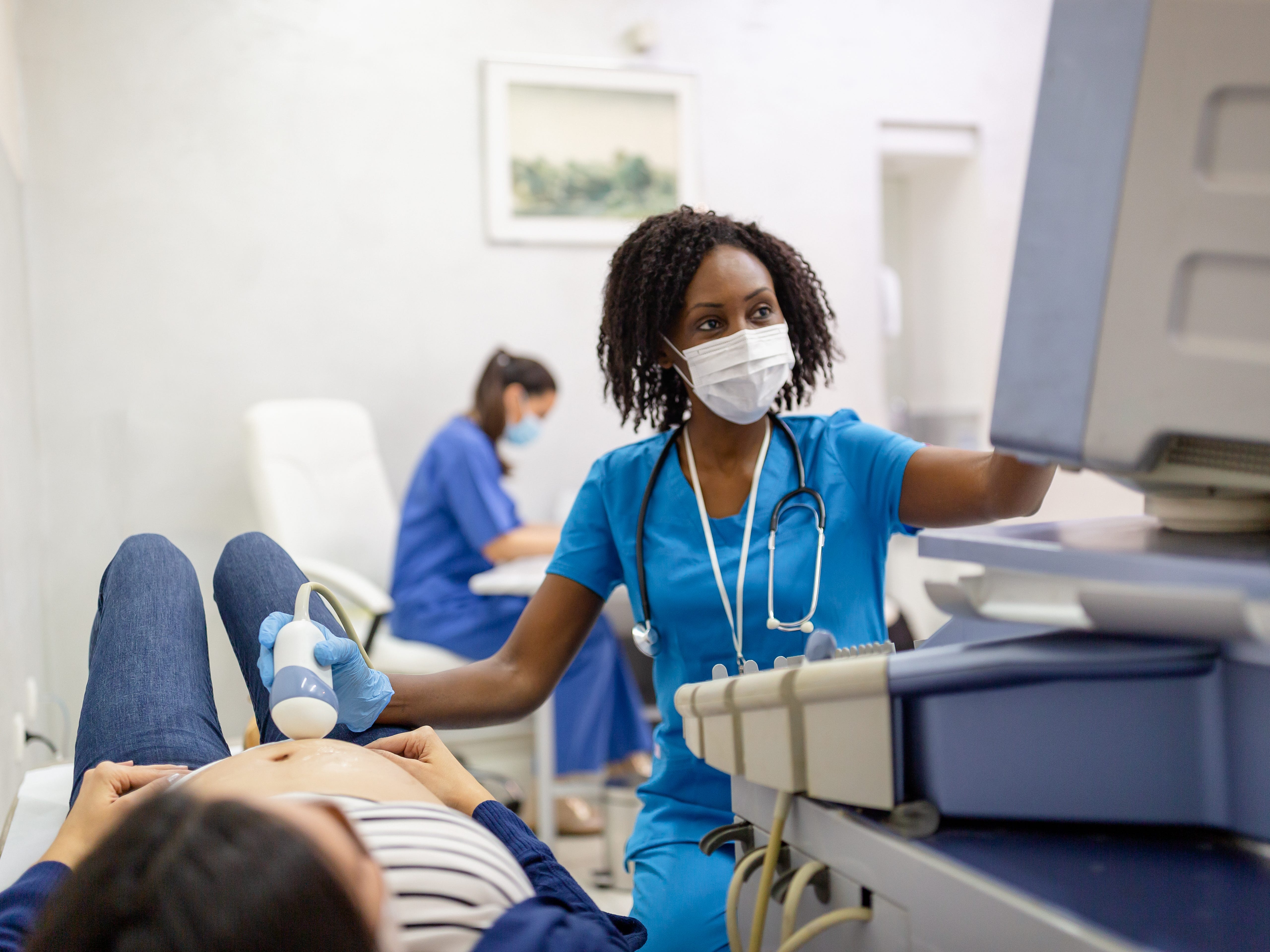 A healthcare worker doing an ultrasound exam