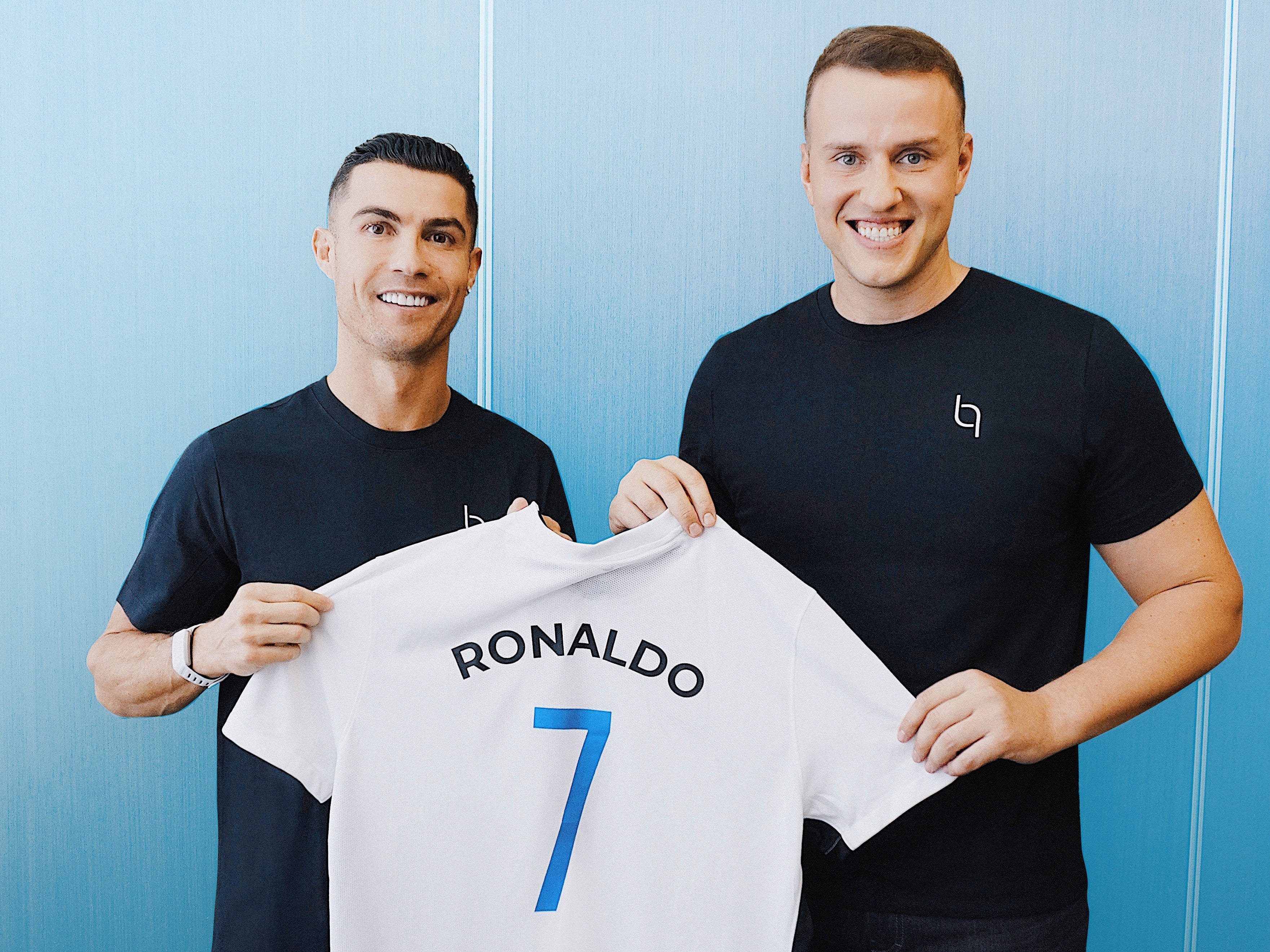 Cristiano Ronaldo and Vadim Fedotov holding up a Ronaldo Bioniq jersey.