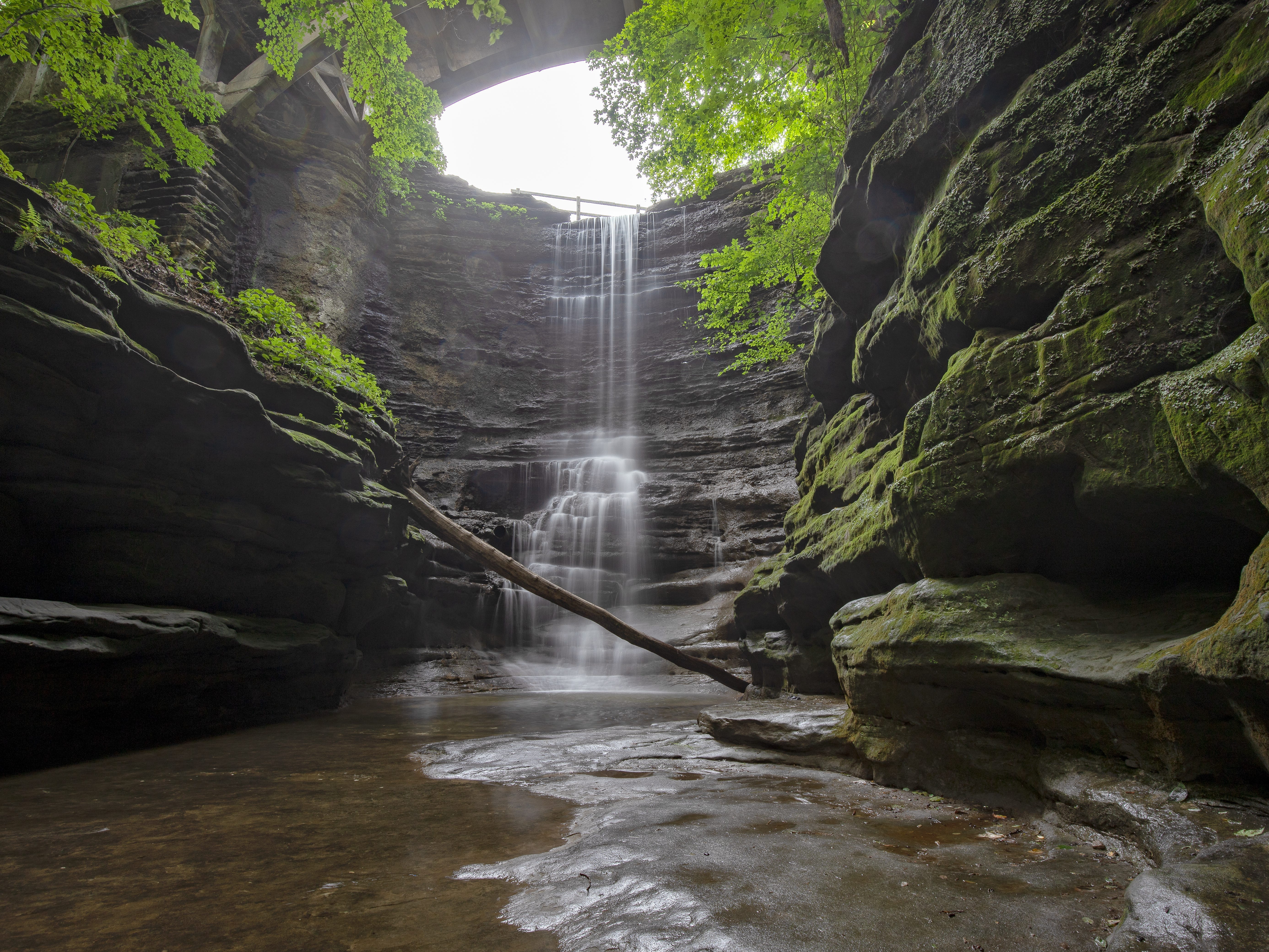 A waterfall in a canyon covered in moss.