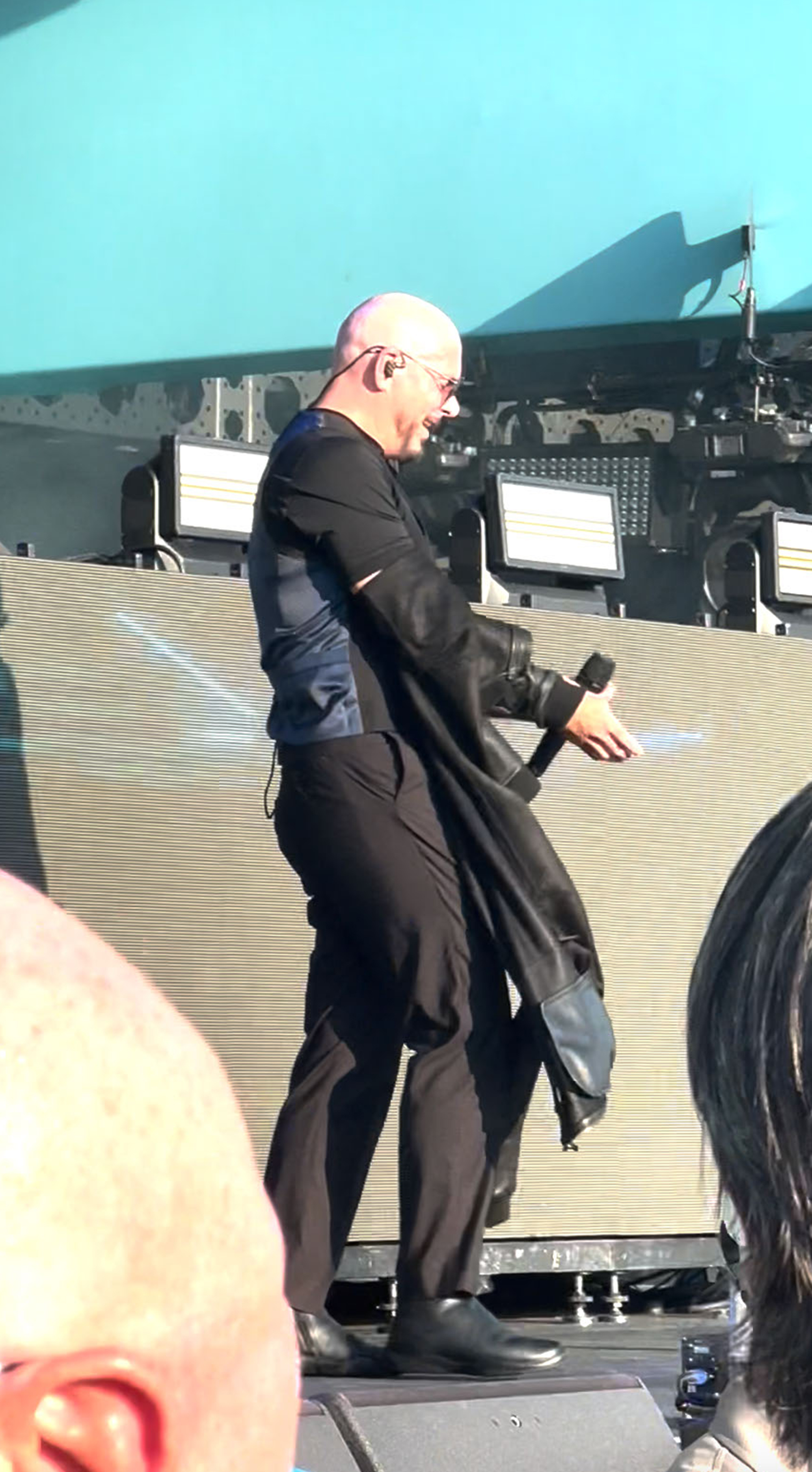 Pitbull taking off his jacket.