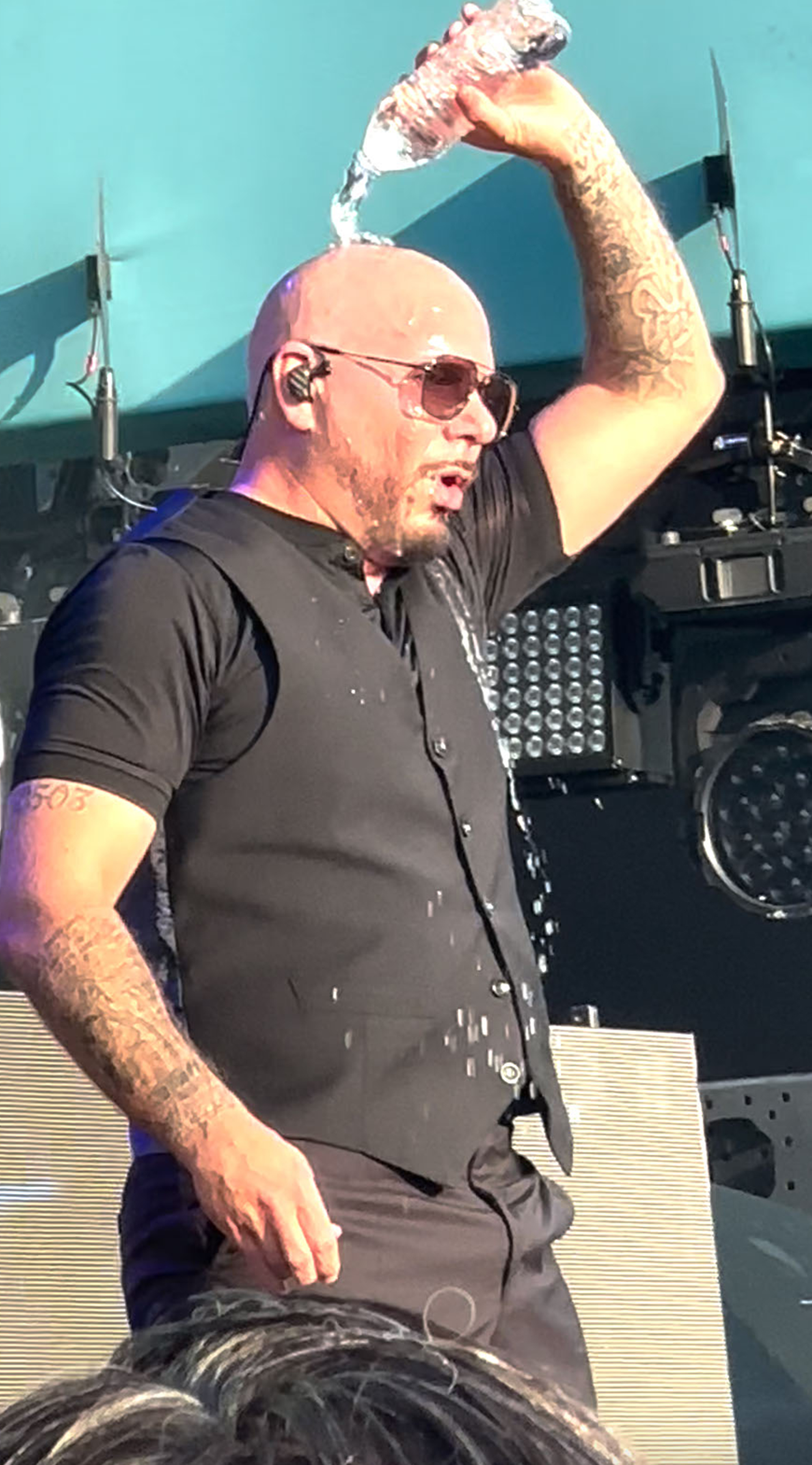Pitbull pouring water on himself.