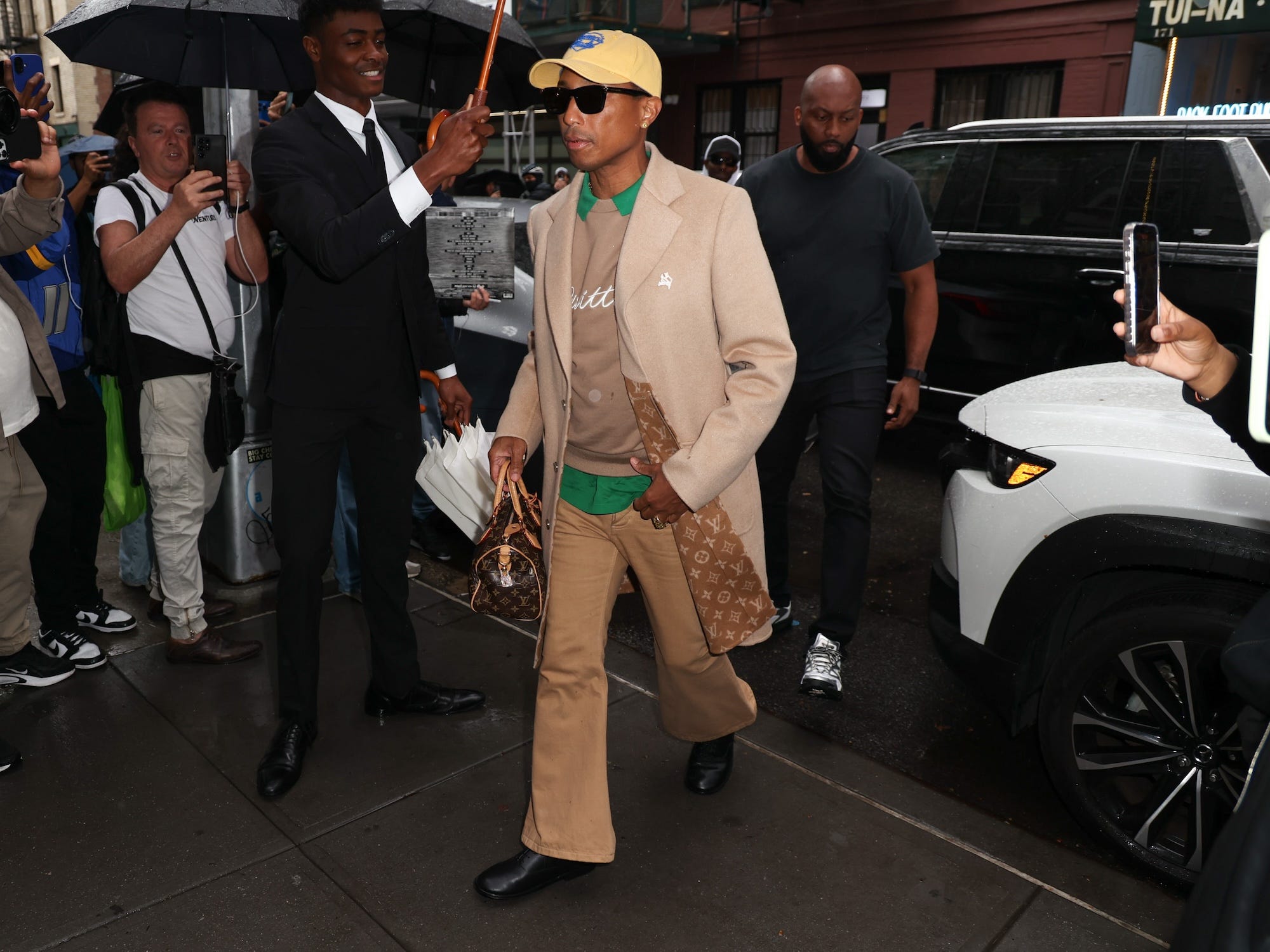 Pharrell Williams walks on a street in a New York.