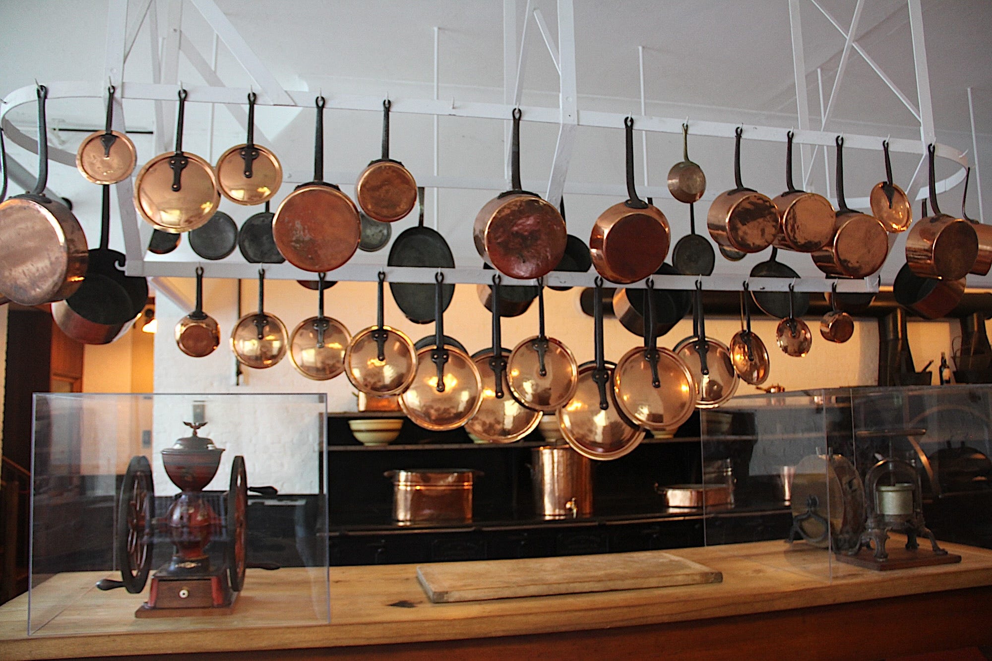 The kitchen at Marble House with copper pots hanging from the ceiling.