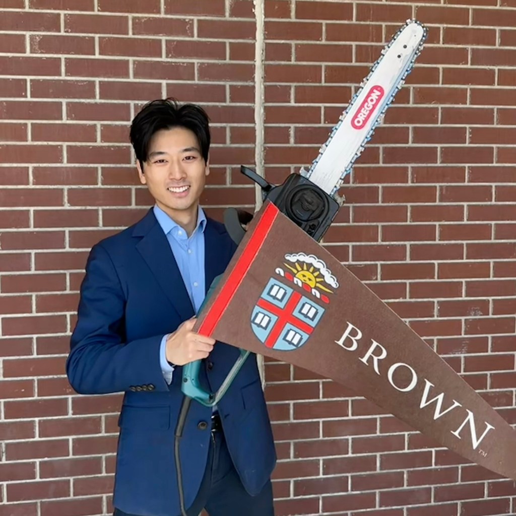 Alex Shieh holding a chainsaw