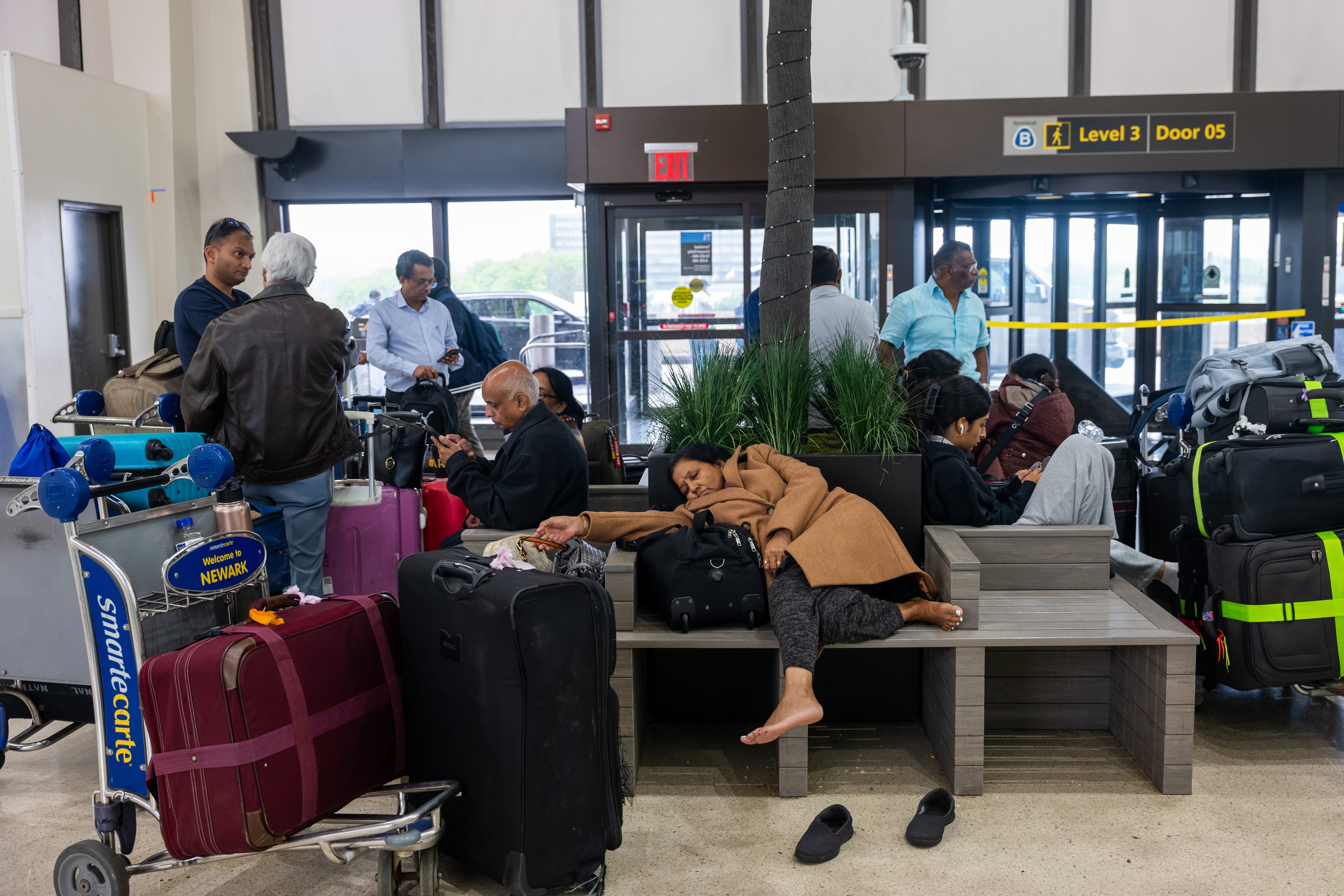 A traveler sleeps during the travel chaos at Newark airport on May 5.