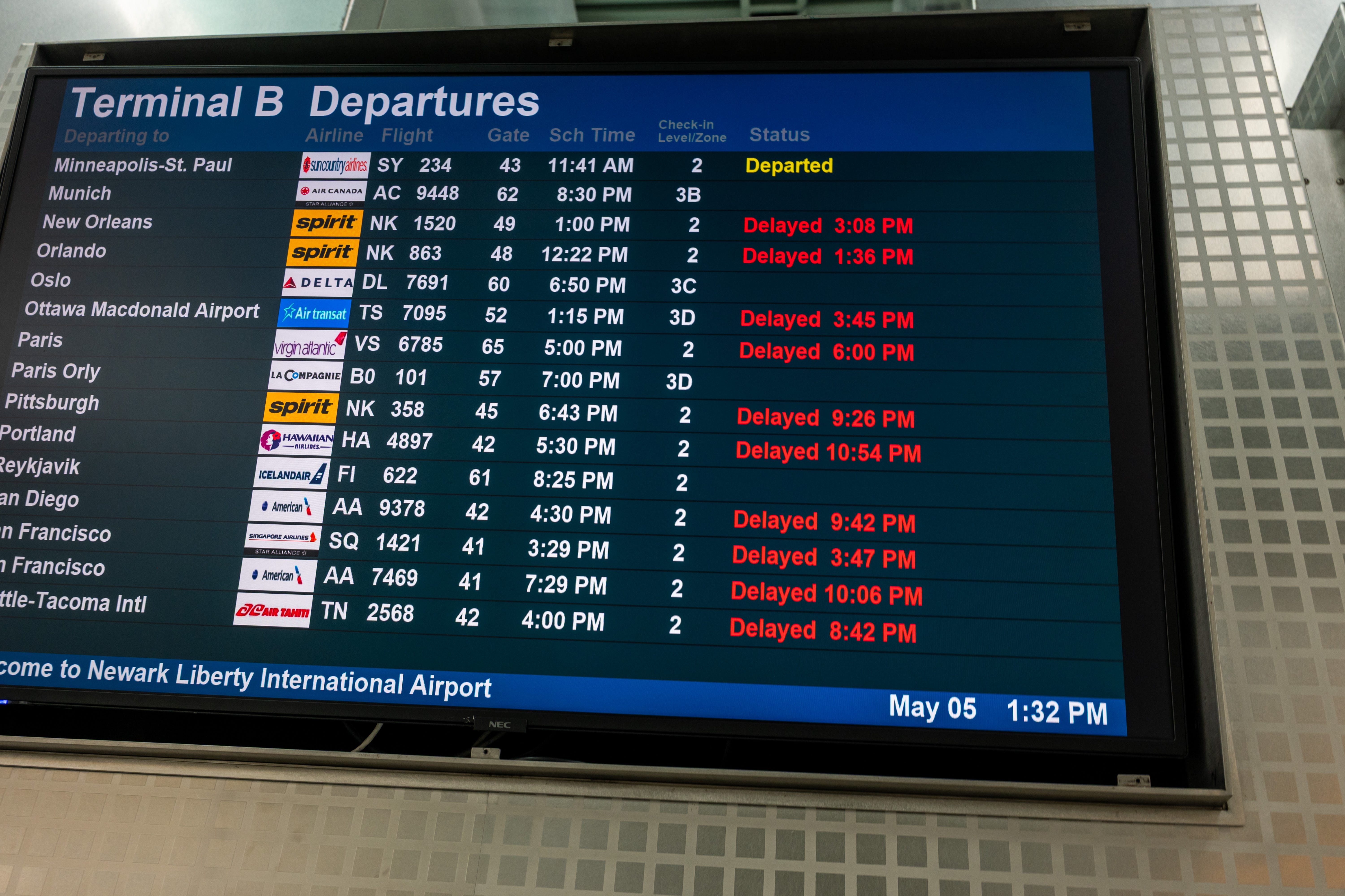 A monitor shows flight delays at Newark International Airport on May 5.