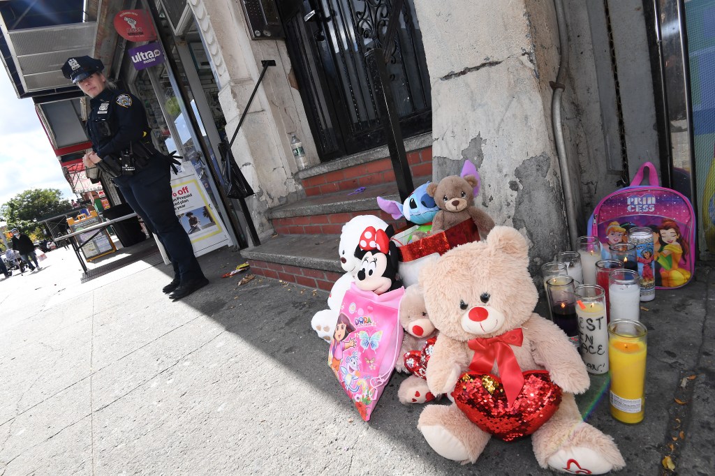 NYPD officers standing guard outside the home of 4-year-old Jahmeik Modlin, who tragically died due to neglect, located at 2484 7th Ave., NYC