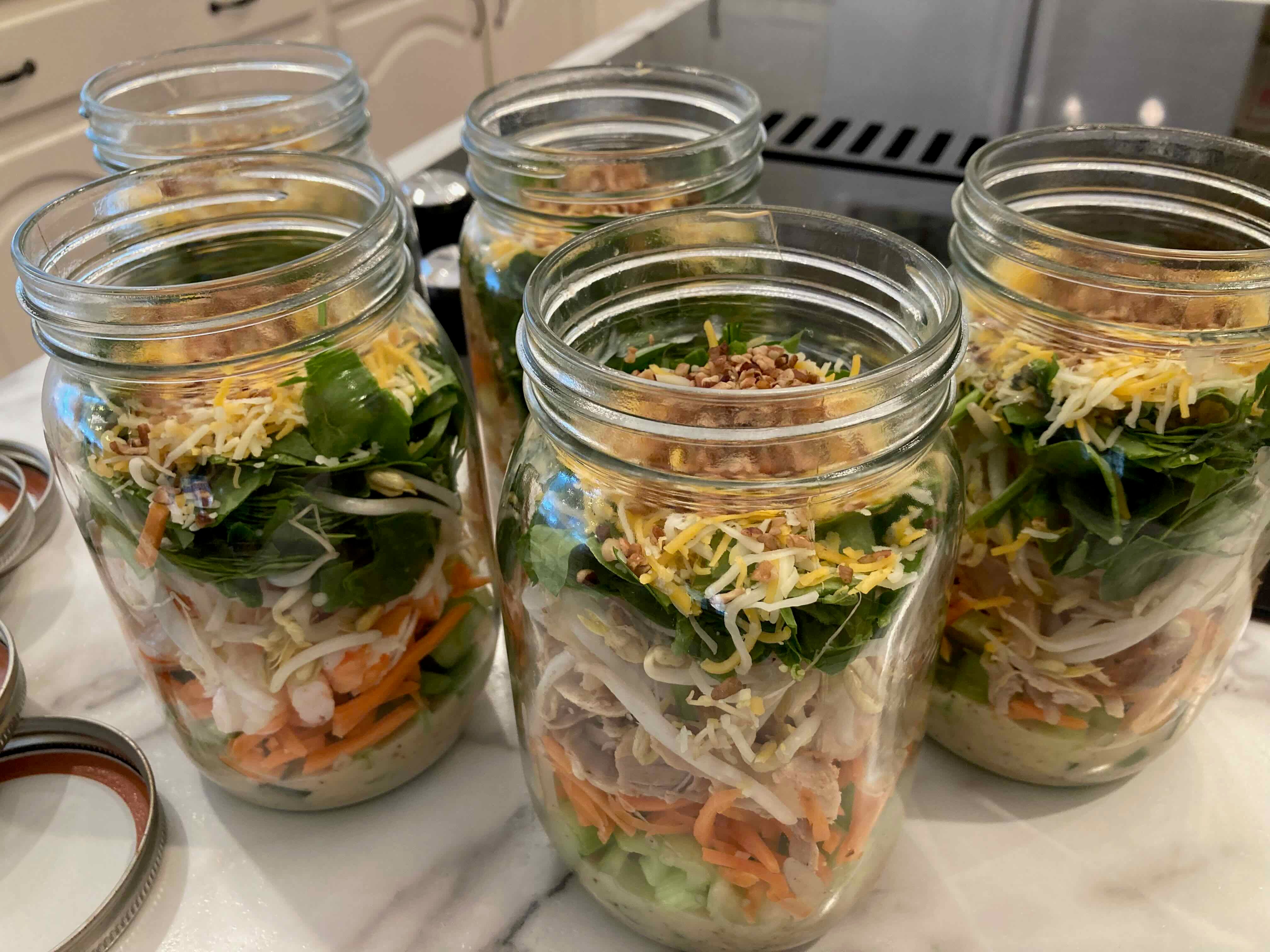 mason jars filled with fresh greens